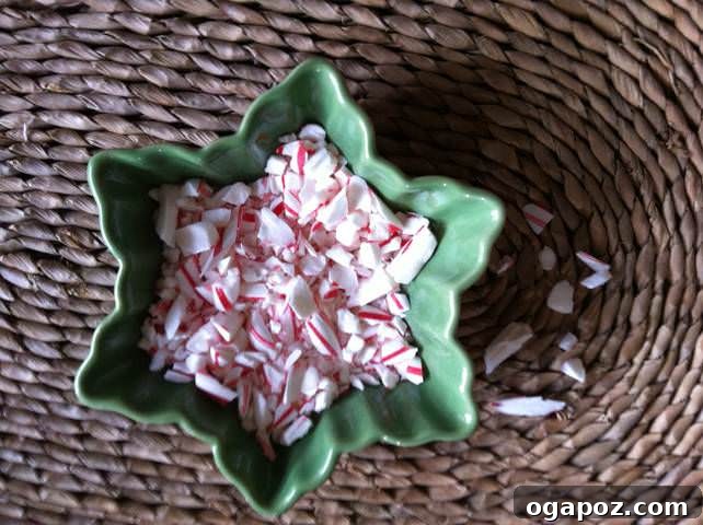 Crushed peppermint candy canes in a sealed bag, prepared to be sprinkled onto the white chocolate layer