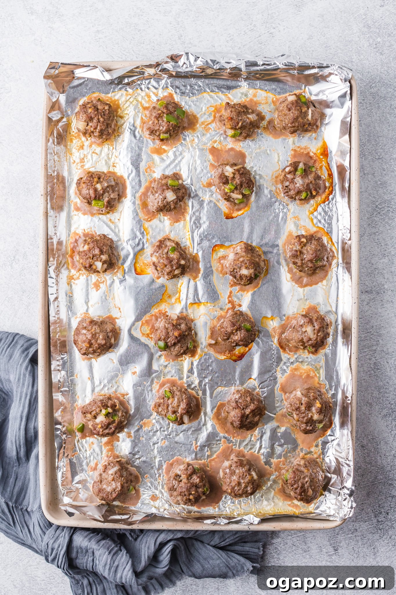 Golden Curry Meatballs 7 Curry Meatballs Recipe on a baking sheet before cooking, showing uniform size.