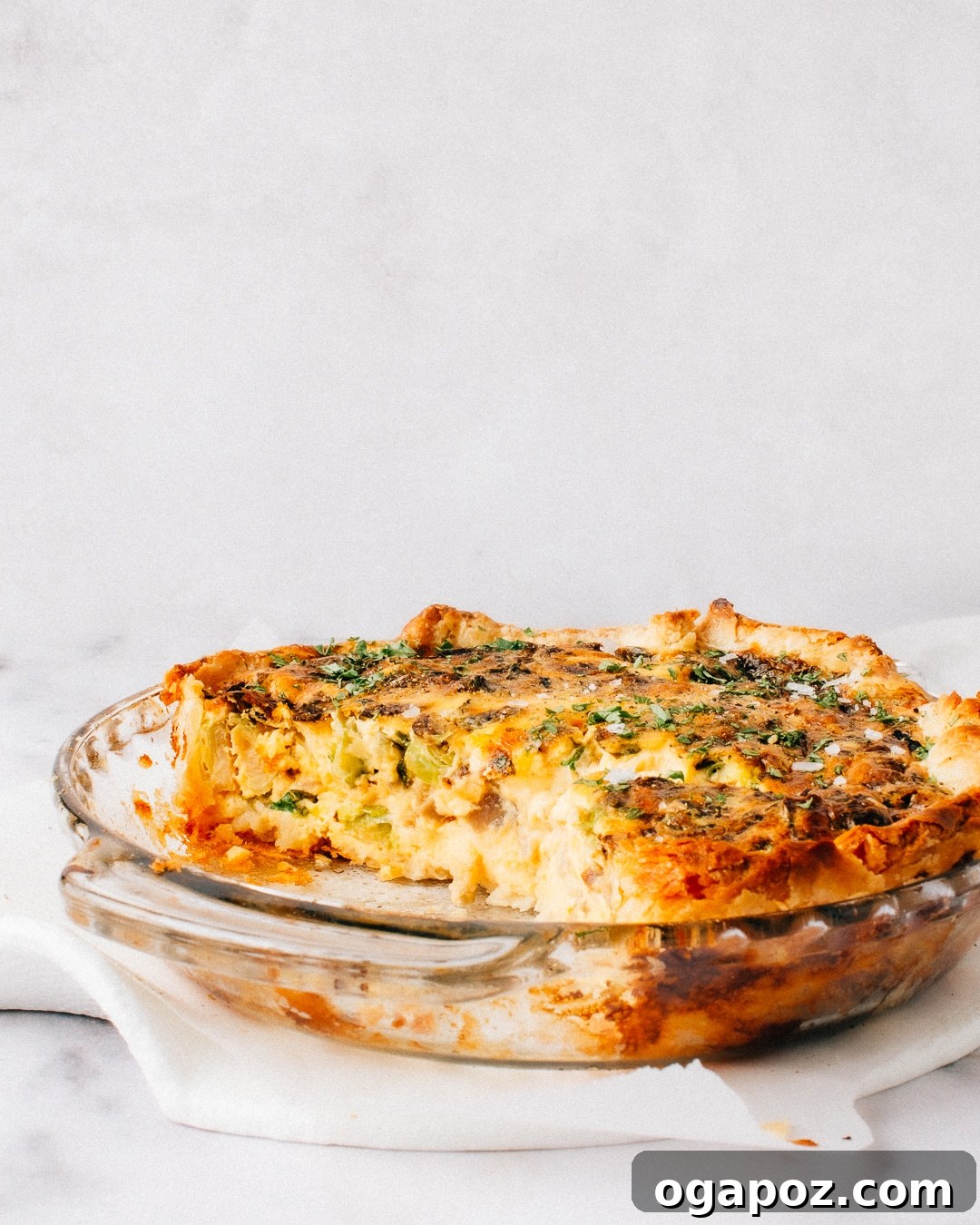 Foolproof and Flavorful Spinach Mushroom Quiche 5 Slice of Spinach Mushroom Quiche on a plate with fresh greens