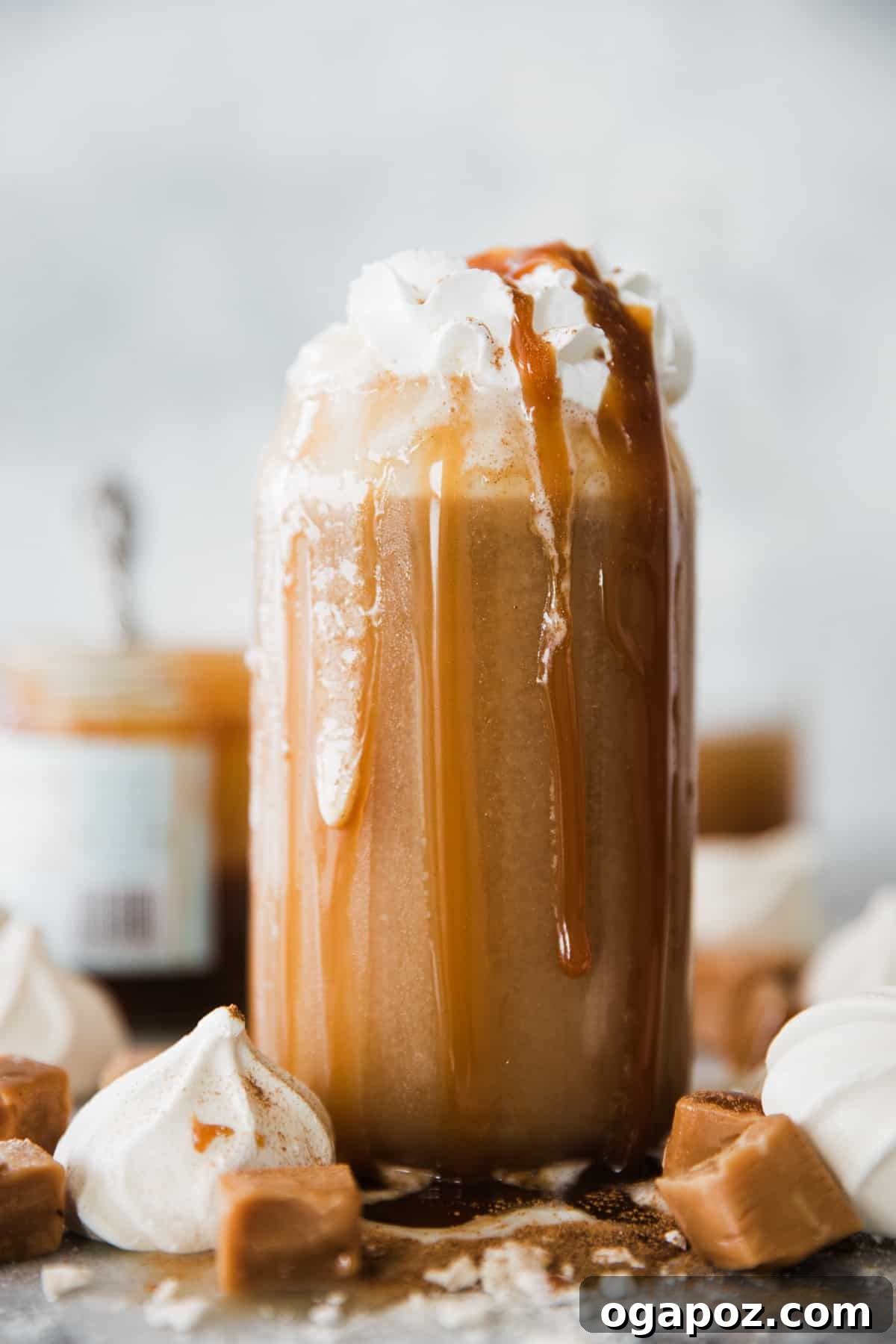 Warm & Festive: 20+ Easy Hot Drinks for a Perfect Christmas 11 Caramel Apple Spiced Drink in a clear mug with a cinnamon stick garnish.