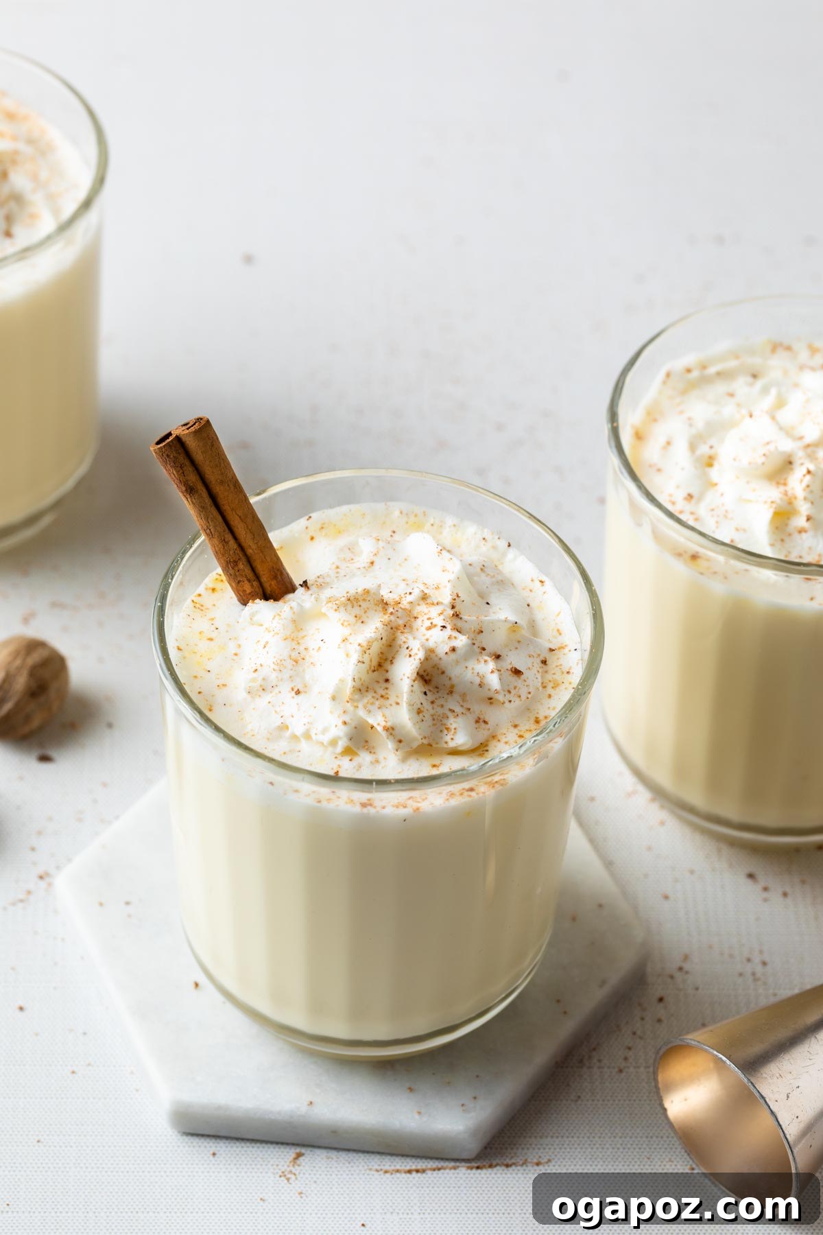 Warm & Festive: 20+ Easy Hot Drinks for a Perfect Christmas 15 Spiked Eggnog in a festive glass, garnished with grated nutmeg.