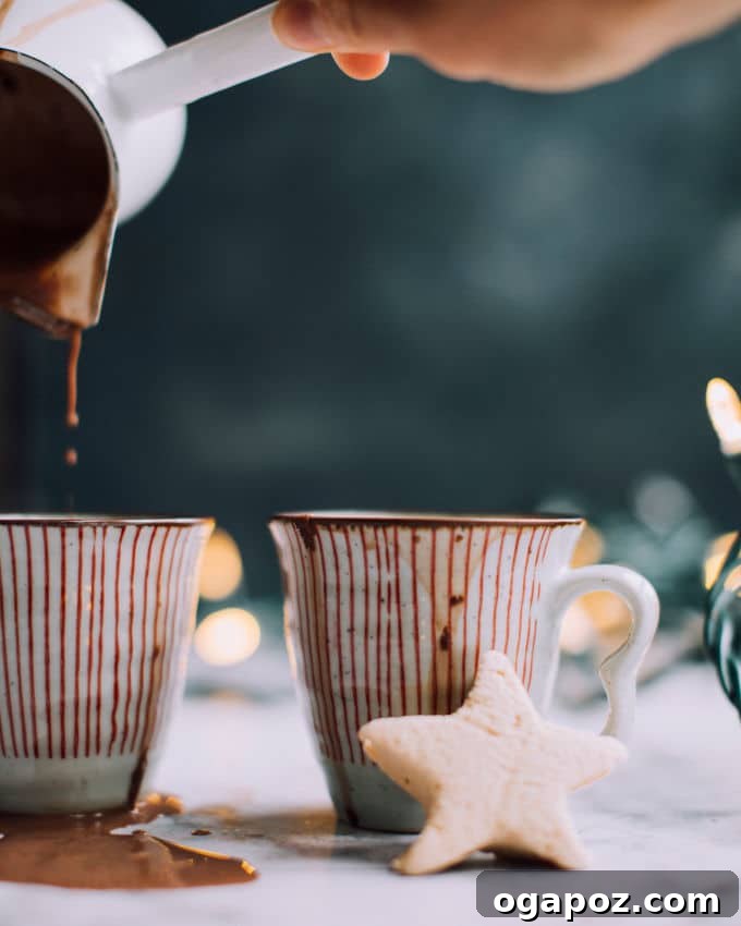 Warm & Festive: 20+ Easy Hot Drinks for a Perfect Christmas 4 Healthy hot chocolate recipe in a mug, garnished with a cinnamon stick.