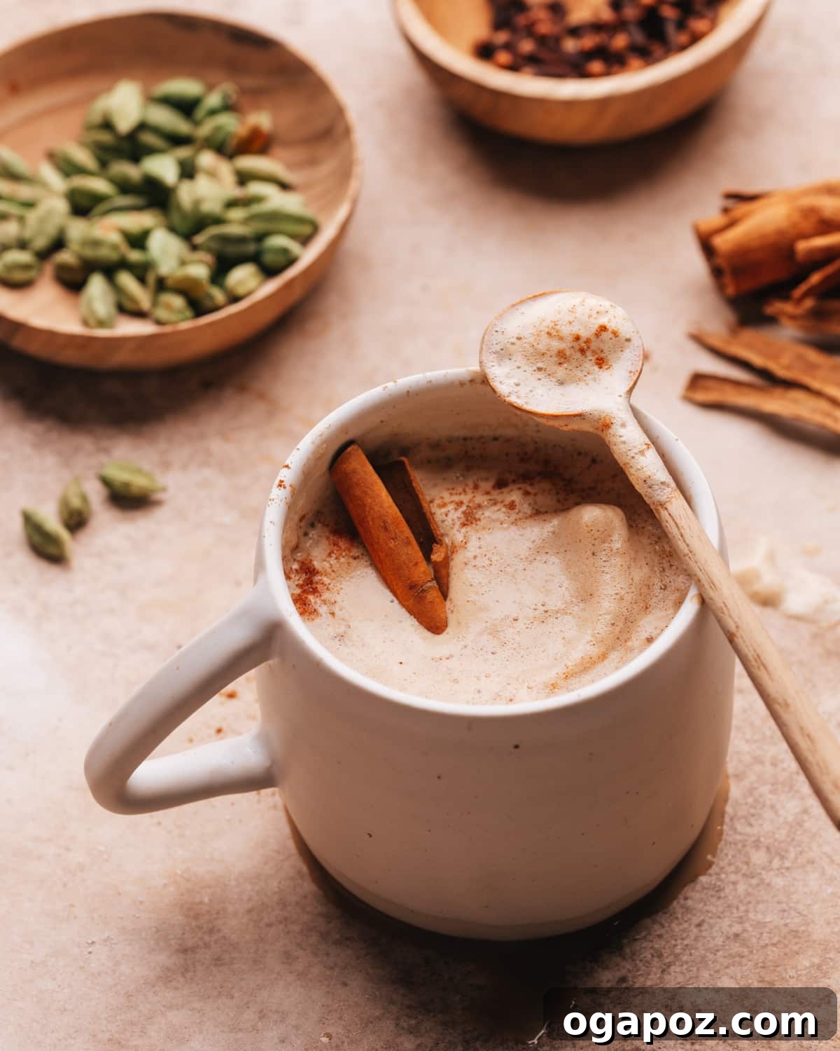 Warm & Festive: 20+ Easy Hot Drinks for a Perfect Christmas 6 Chai Coffee recipe served in a clear mug, showing its creamy layers.