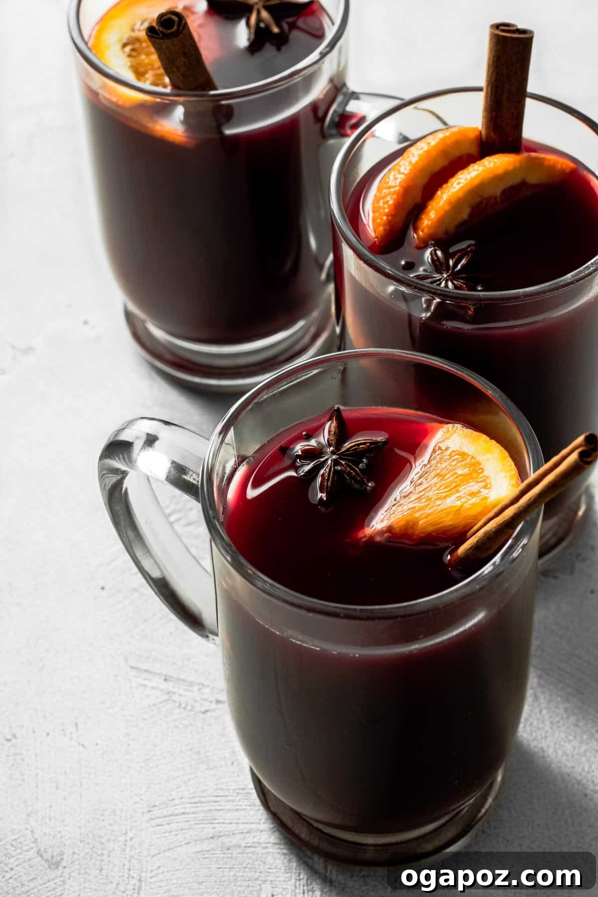Warm & Festive: 20+ Easy Hot Drinks for a Perfect Christmas 7 Slow Cooker Mulled Wine, showcasing a deep red hue with floating spices and orange slices.