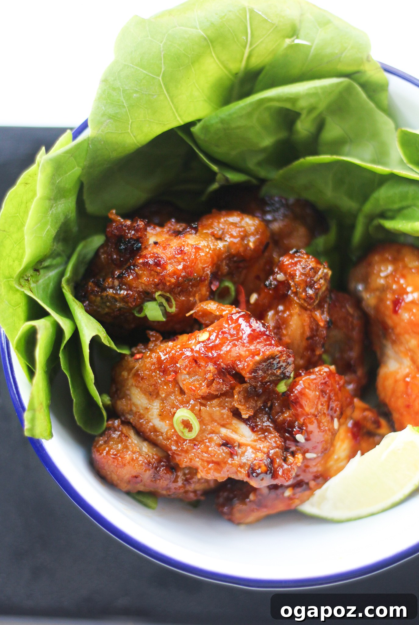 Air Fryer Chicken Wings Recipe on a plate, garnished with fresh green onions.