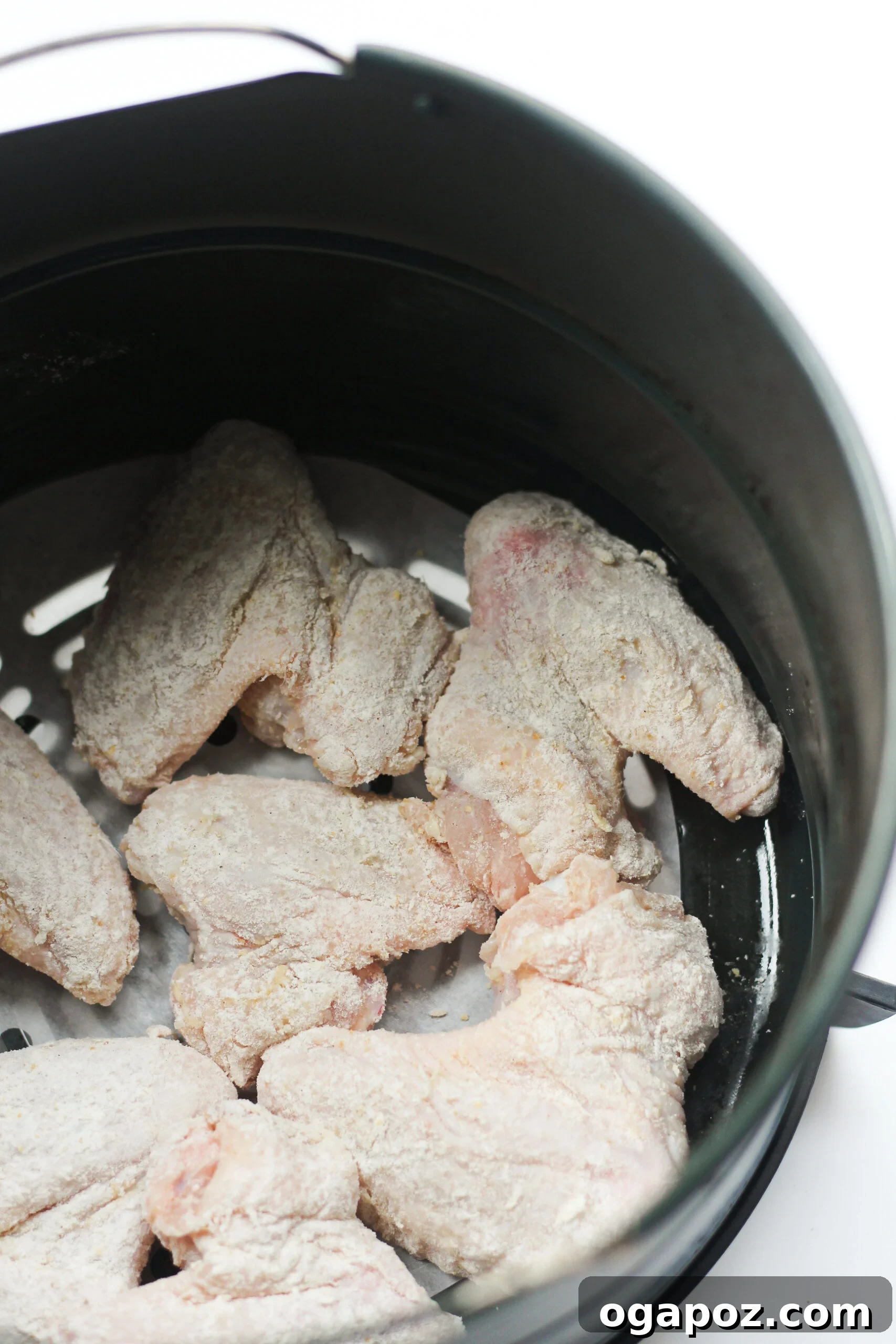 Air Fryer Chicken Wings Recipe cooking in an air fryer.