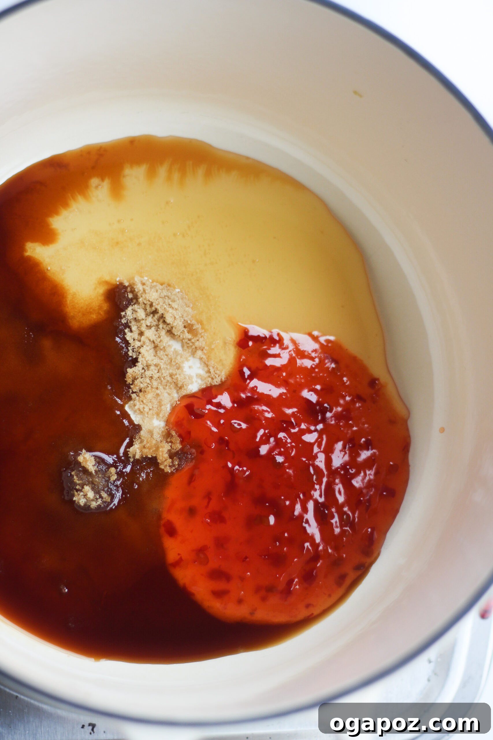Sweet and tangy sauce for Air Fryer Chicken Wings Recipe simmering in a skillet.
