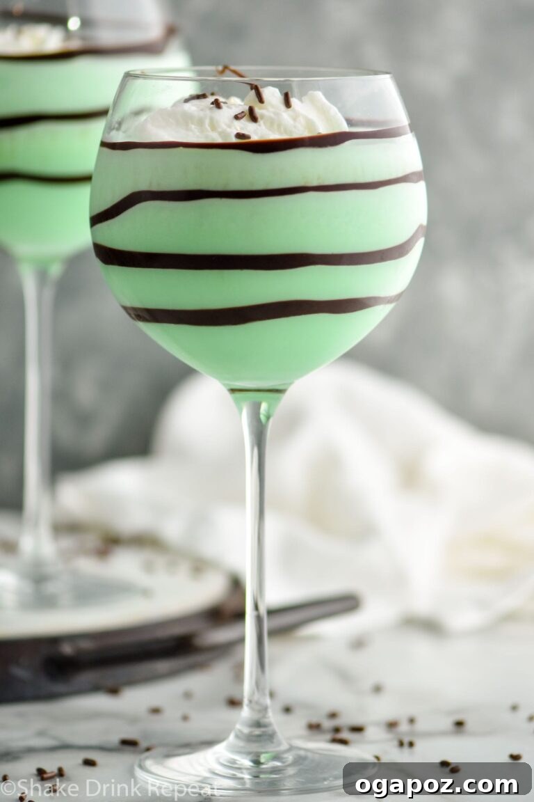Emerald Elixirs: Creme De Menthe Holiday Cocktails 2 Grasshopper cocktail, a classic green Christmas drink with creme de menthe, garnished with chocolate shavings.