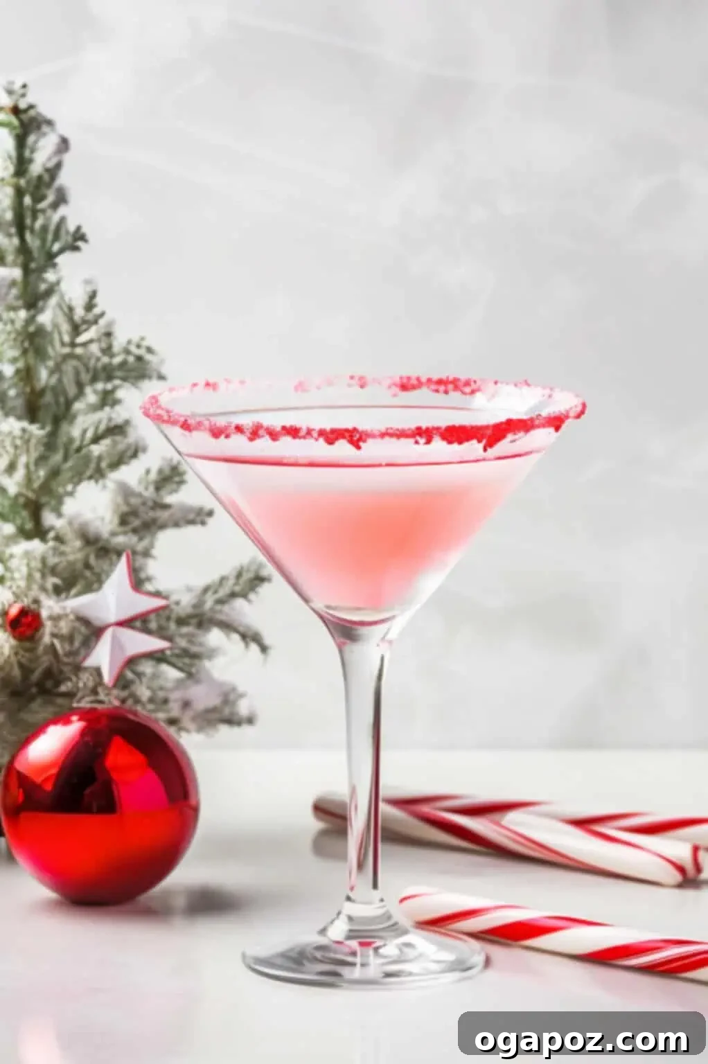 Emerald Elixirs: Creme De Menthe Holiday Cocktails 3 Candy Cane Martini, a festive Crème de Menthe cocktail rimmed with crushed candy canes.