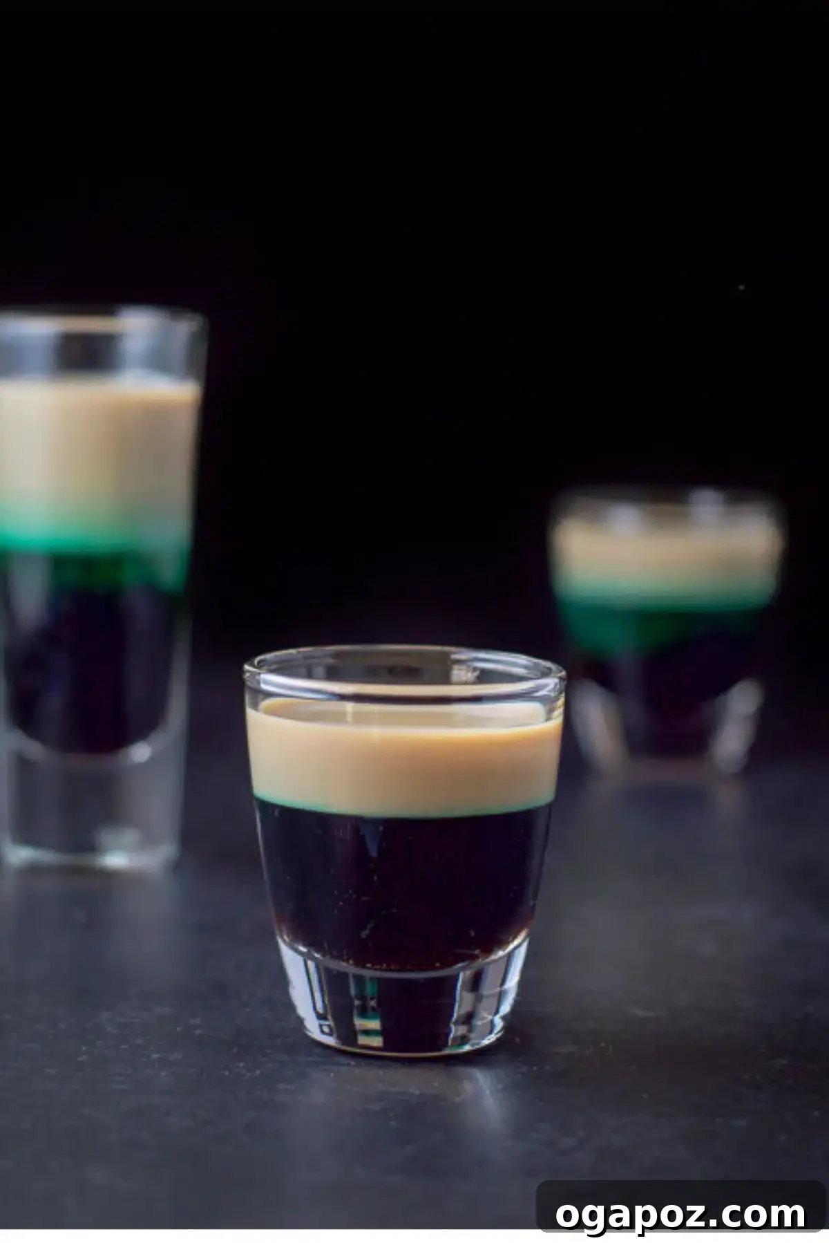 Emerald Elixirs: Creme De Menthe Holiday Cocktails 10 After Eight Shot, a sweet and minty layered shot inspired by the famous chocolates.