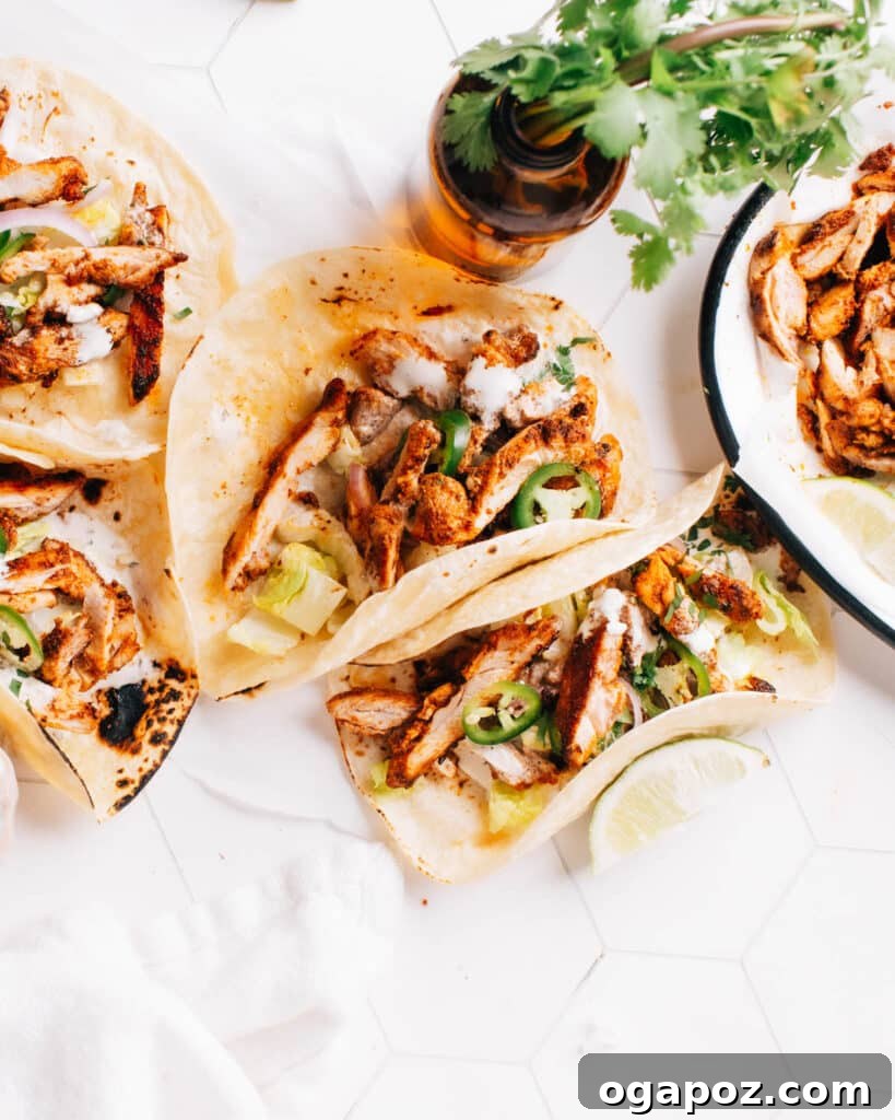 28 Healthy Chicken Recipes Easy Delicious Dietitian Approved 13 Vibrant Chicken street tacos on a wooden table, garnished with fresh cilantro and lime