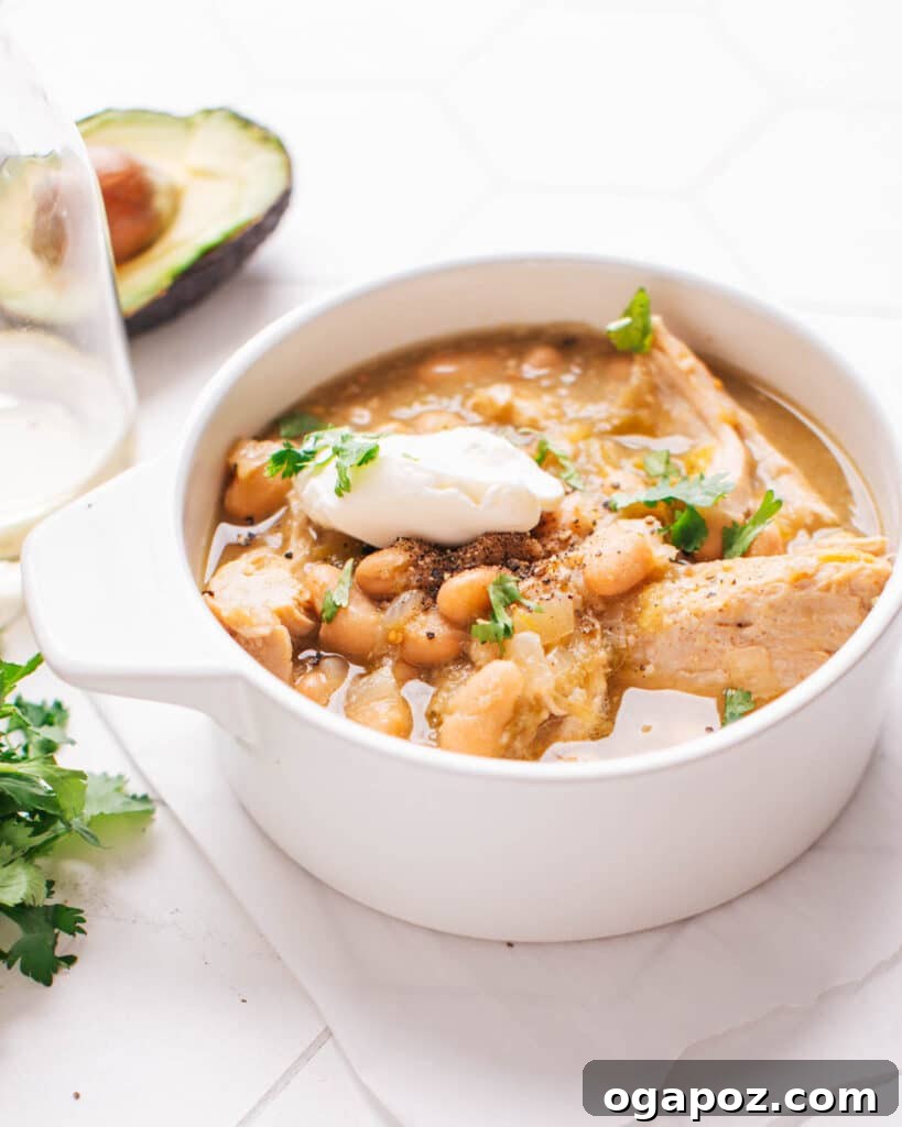 28 Healthy Chicken Recipes Easy Delicious Dietitian Approved 23 Hearty Green Chicken Chili served in a bowl, garnished with fresh cilantro and sour cream