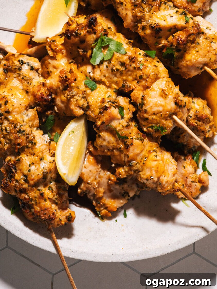 28 Healthy Chicken Recipes Easy Delicious Dietitian Approved 4 Grilled Chicken skewers on a plate with fresh lemon wedges and herbs