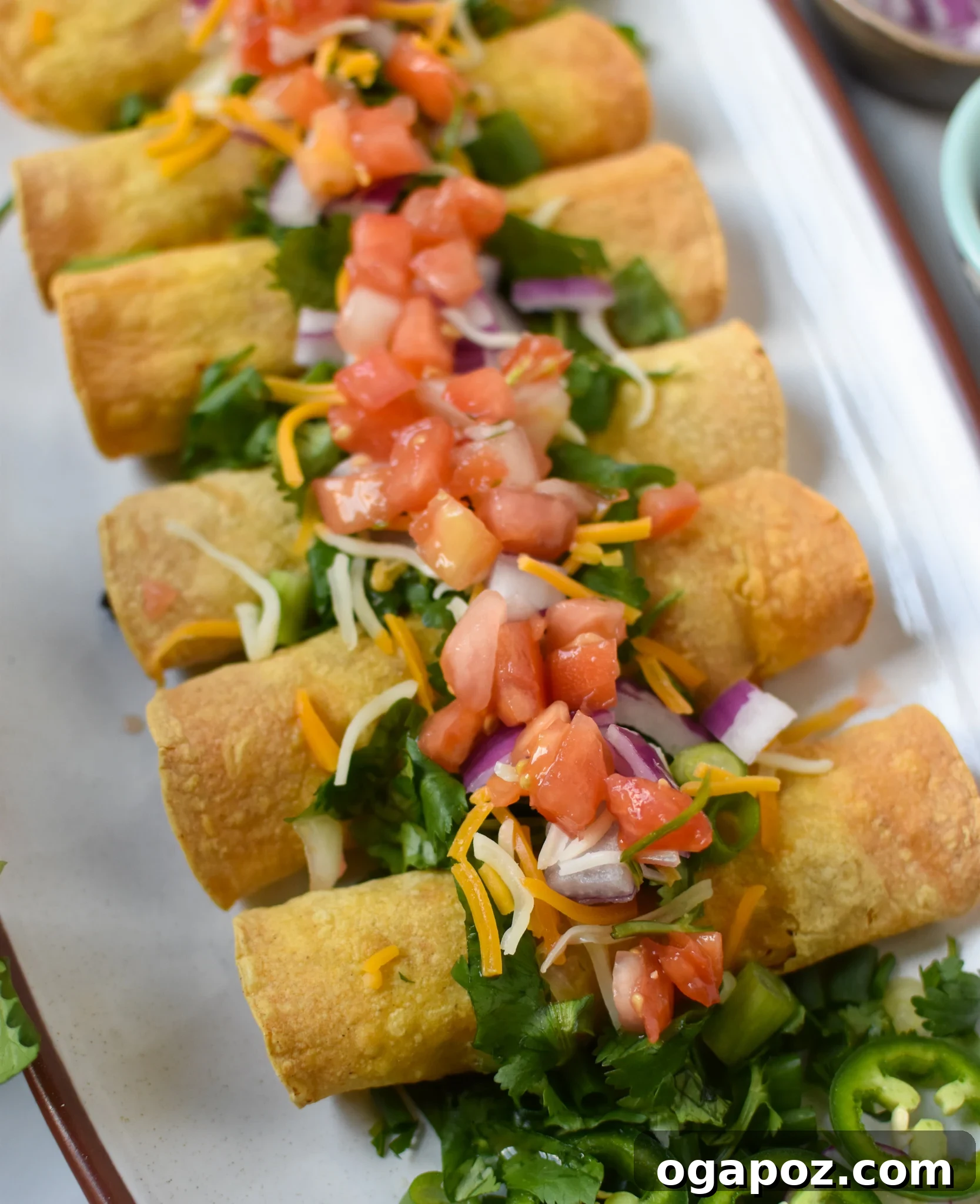 Crispy Air Fryer Pork Taquitos 8 Close-up of golden Air Fryer Pork Taquitos generously topped with fresh cilantro, ready to be enjoyed.