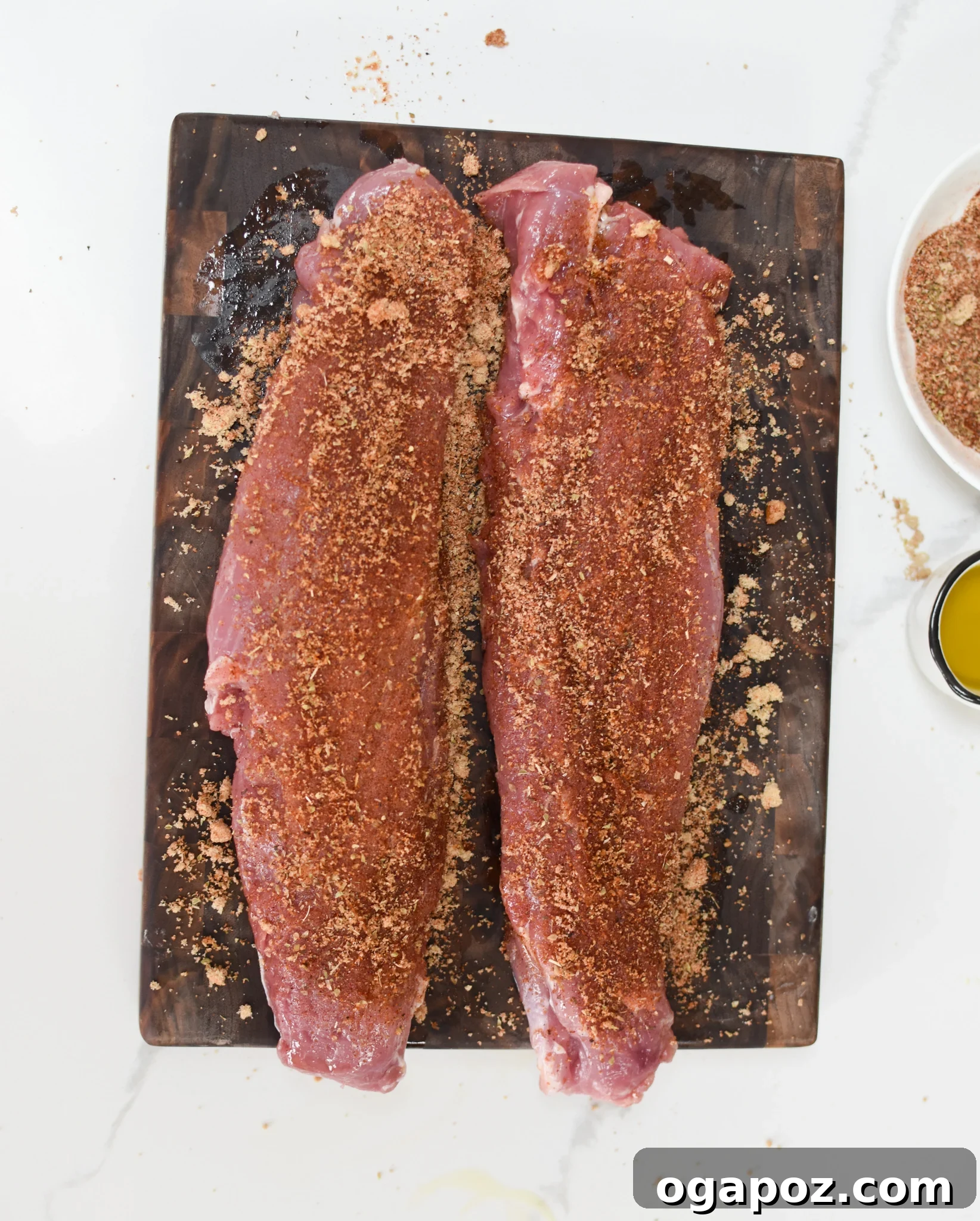 Golden Air Fryer Pork Tenderloin 5 Pork tenderloin generously coated with the smoky-sweet spice rub, ready for the air fryer, resting on a cutting board.