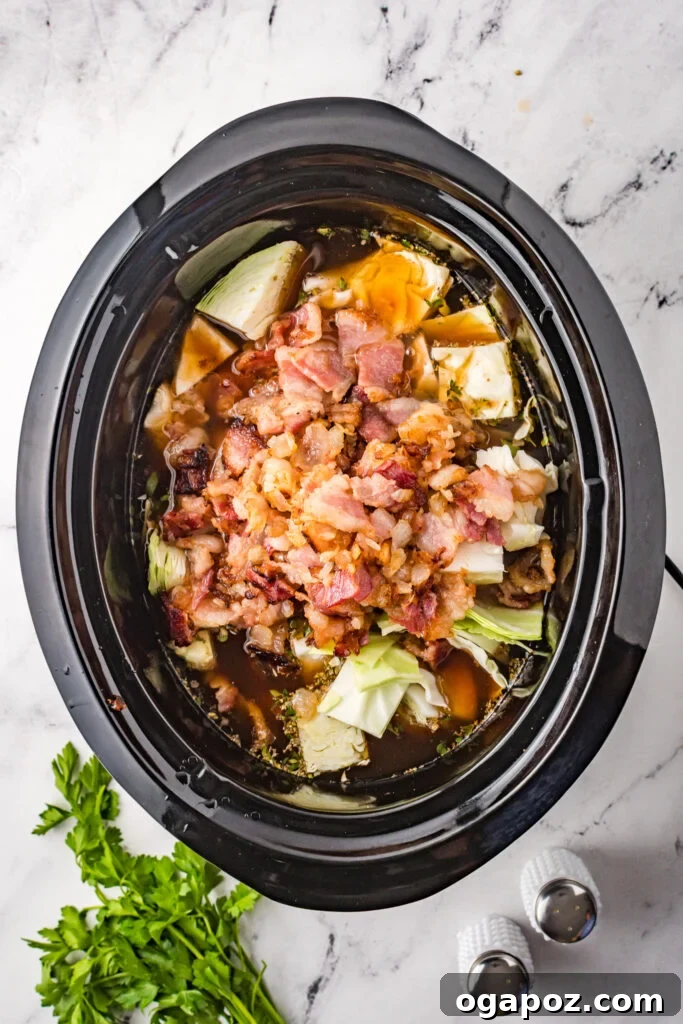 Unstuffed Cabbage Soup 5 Cabbage Roll Soup simmering gently in a slow cooker, steam rising.
