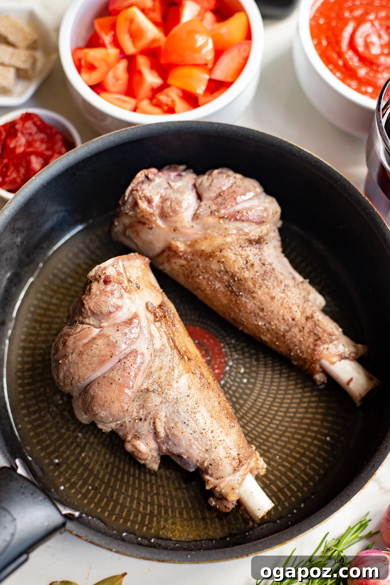 Fall-Off-The-Bone Braised Lamb Shanks 6 Braised Lamb Shanks Recipe: lamb shanks searing in a skillet.