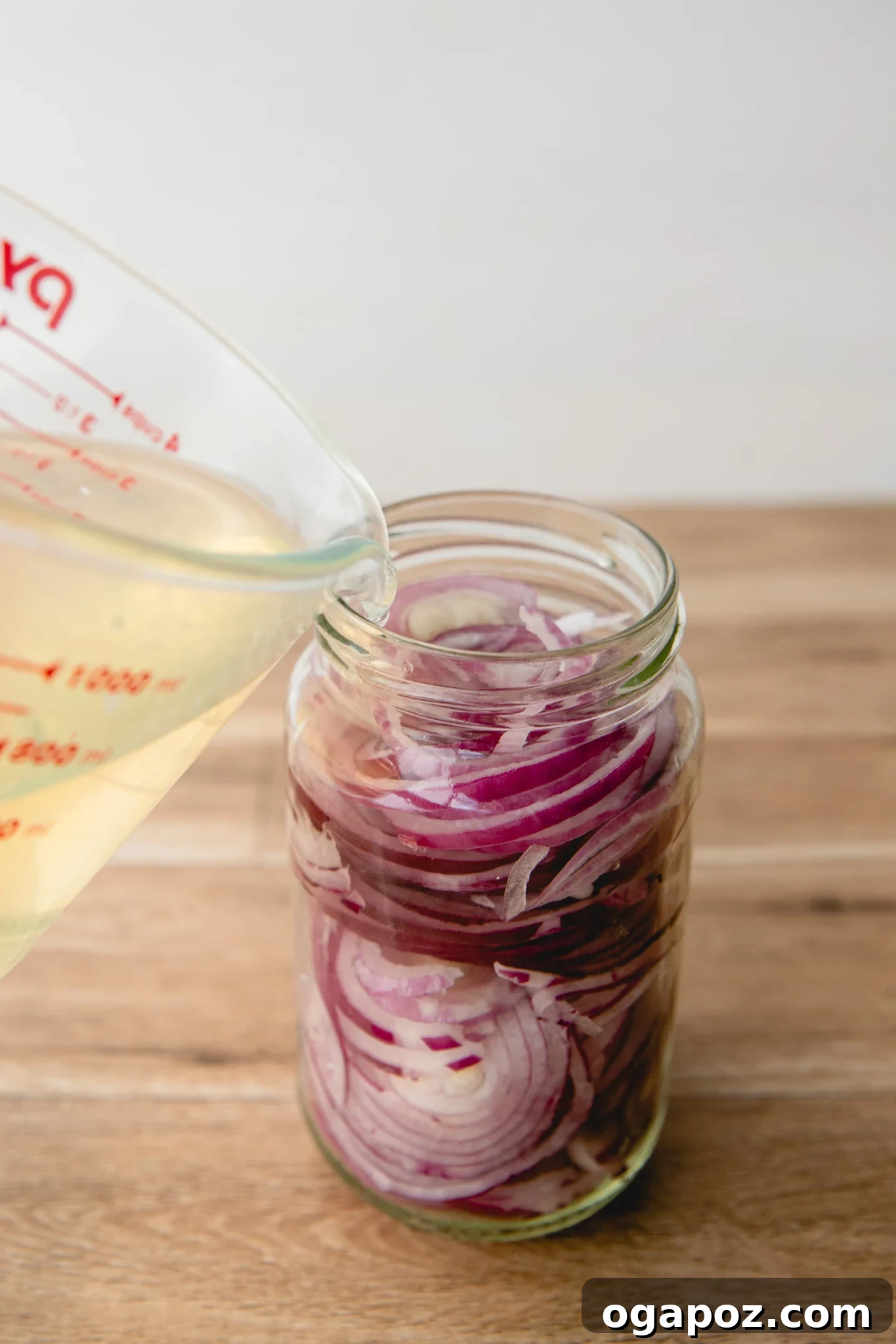 Blush Hour Onions 6 Adding hot water to the pickling brine mixture.