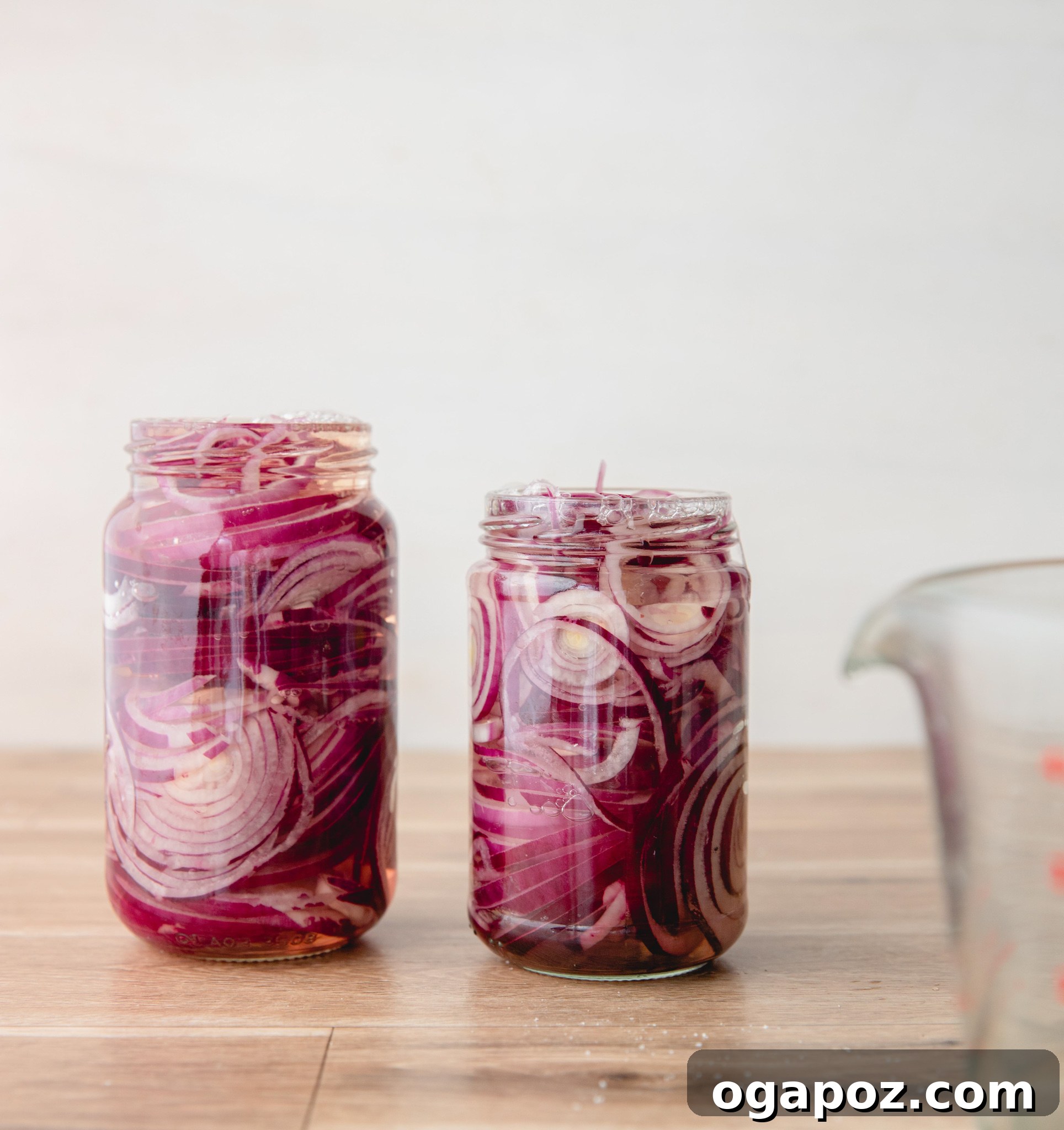 Blush Hour Onions 7 Two mason jars filled with quick pickled red onions.