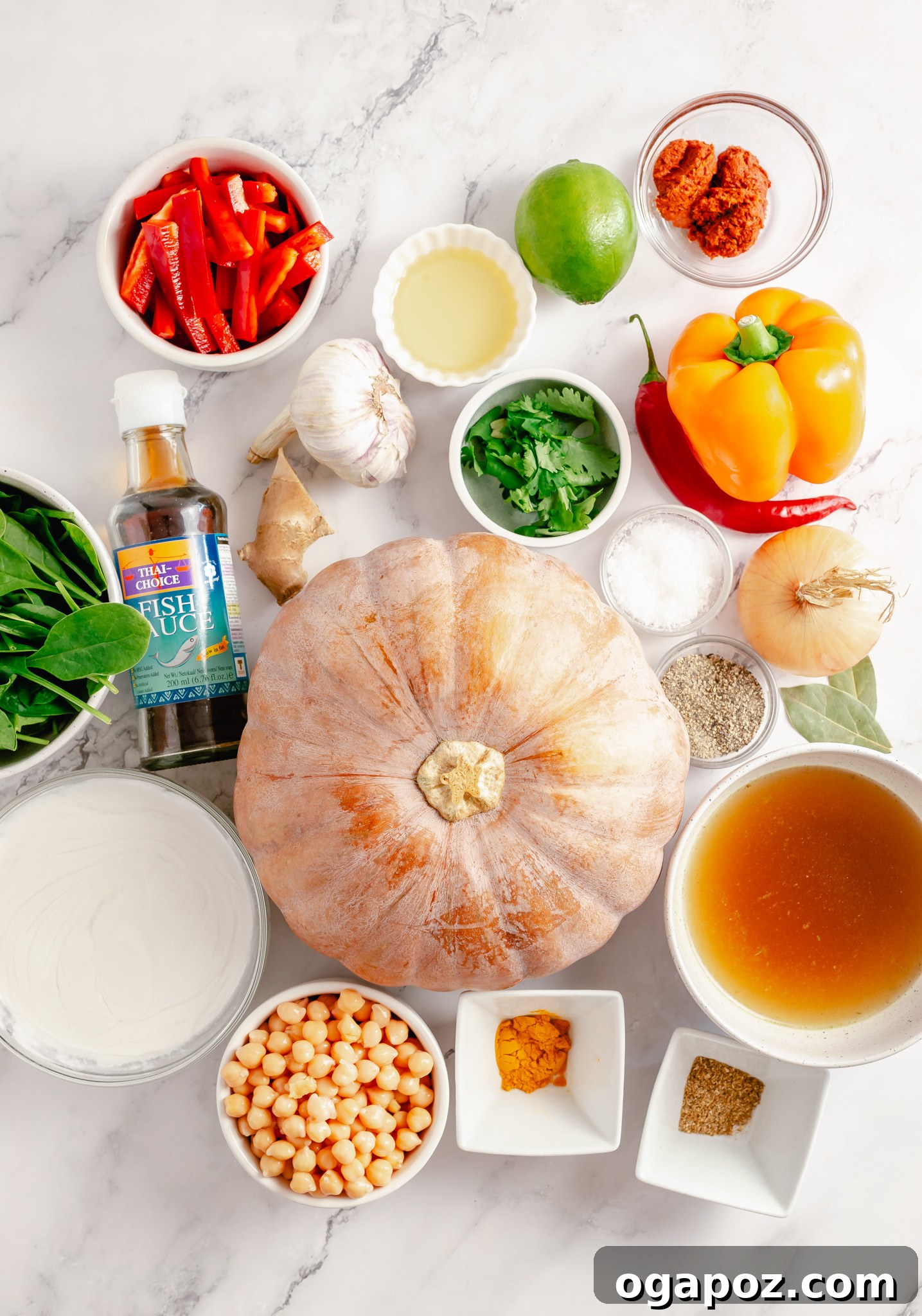 Fresh ingredients for Pumpkin Curry Recipe laid out on a wooden board.