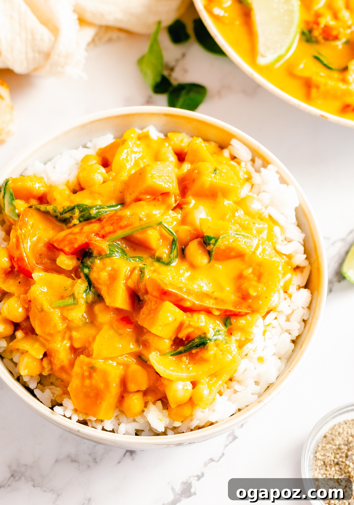 Pumpkin Curry Recipe served over rice in a white bowl.