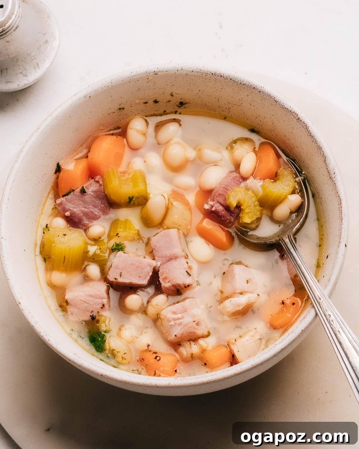 Deliciously Simple Ham Bone Soup Hearty and Flavorful 2 A steaming bowl of homemade Ham Bone Soup, garnished with fresh parsley.
