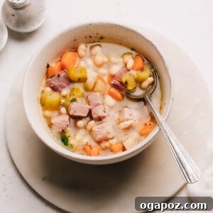 Deliciously Simple Ham Bone Soup Hearty and Flavorful 10 Ham bone soup recipe in a bowl with a spoon, ready to be served.