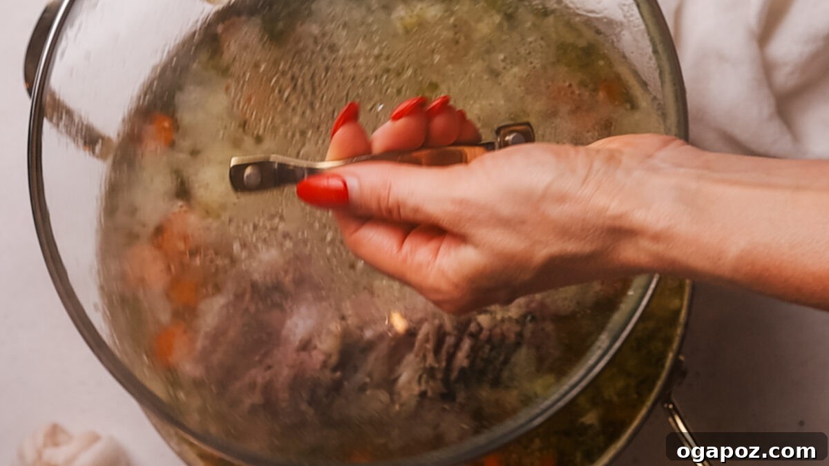 Deliciously Simple Ham Bone Soup Hearty and Flavorful 7 Step 4: Adding canned white beans to the simmering ham bone soup.