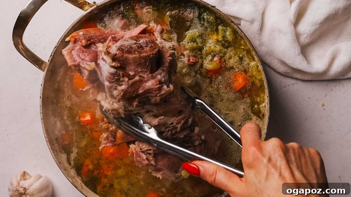 Deliciously Simple Ham Bone Soup Hearty and Flavorful 8 Step 5: Shredded ham being stirred back into the finished ham bone soup.