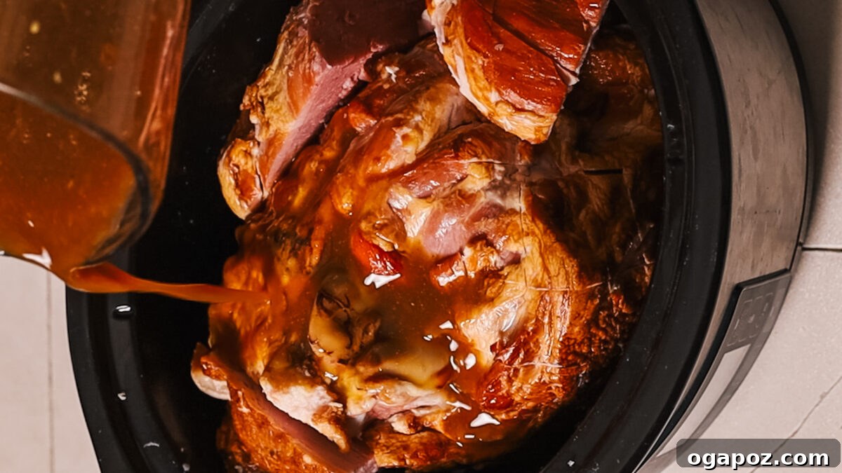 The Perfect Ham Glaze 6 Applying glaze to ham using a basting brush.