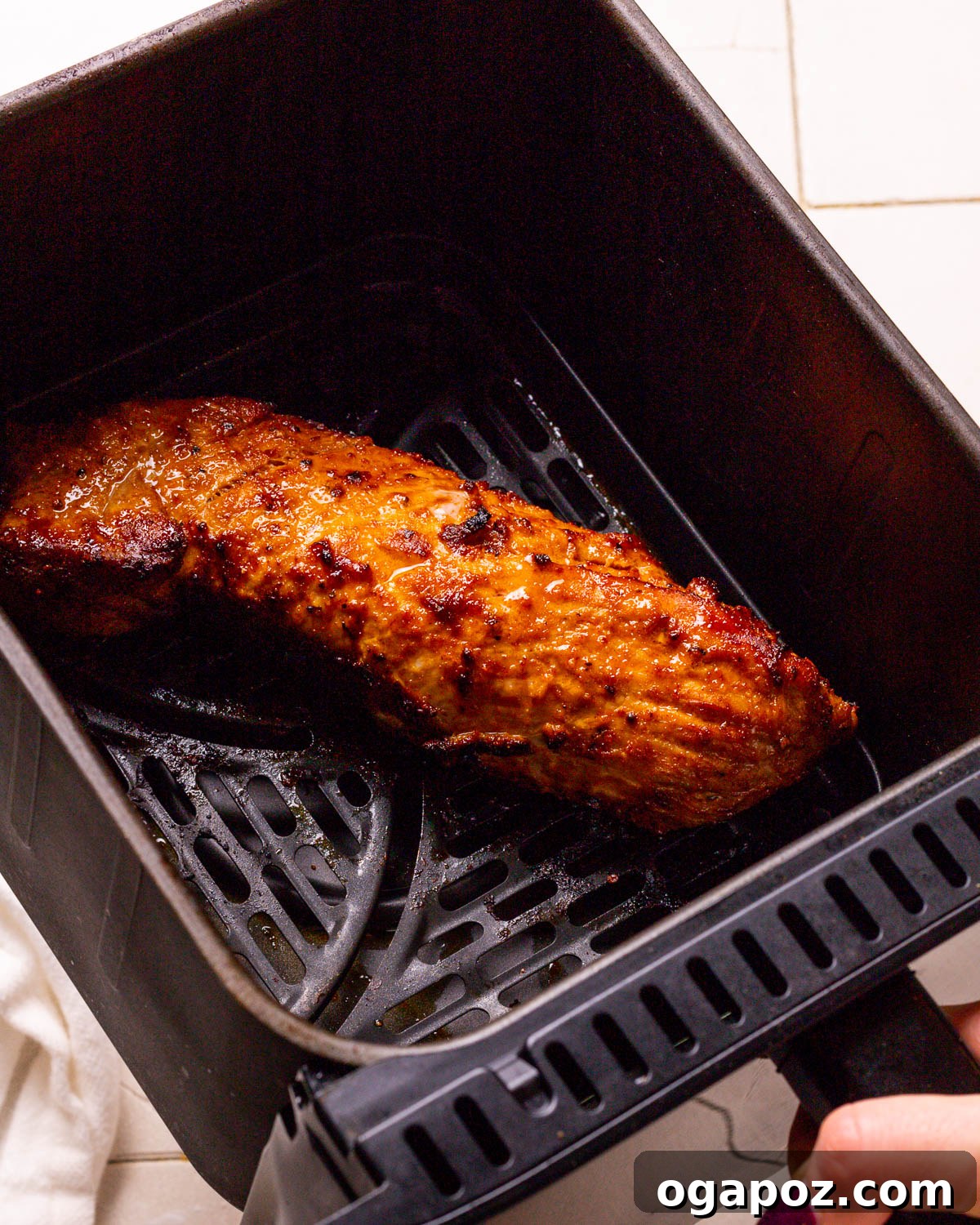 Succulent Air Fried Pork Tenderloin 9 Air Fryer Pork Tenderloin: Perfectly cooked tenderloin in the air fryer basket.