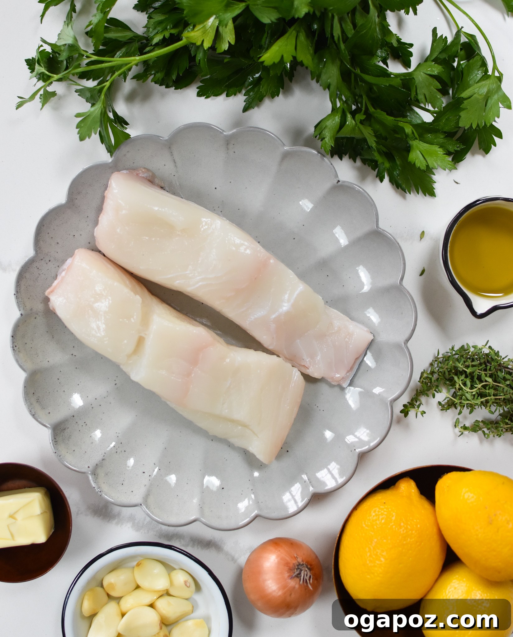 Zesty Lemon Garlic Halibut 3 Fresh ingredients laid out for Lemon Garlic Halibut Recipe, including raw halibut fillets, minced garlic, diced shallots, a whole lemon, fresh parsley, and a selection of spices.
