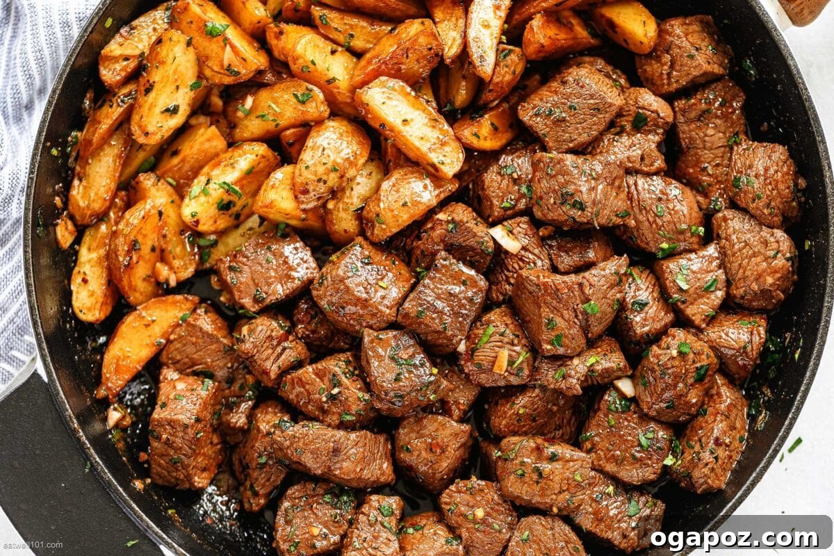Mouthwatering Boneless Beef Ideas 21 Garlic butter steak bites with potatoes in skillet, ready to be devoured.