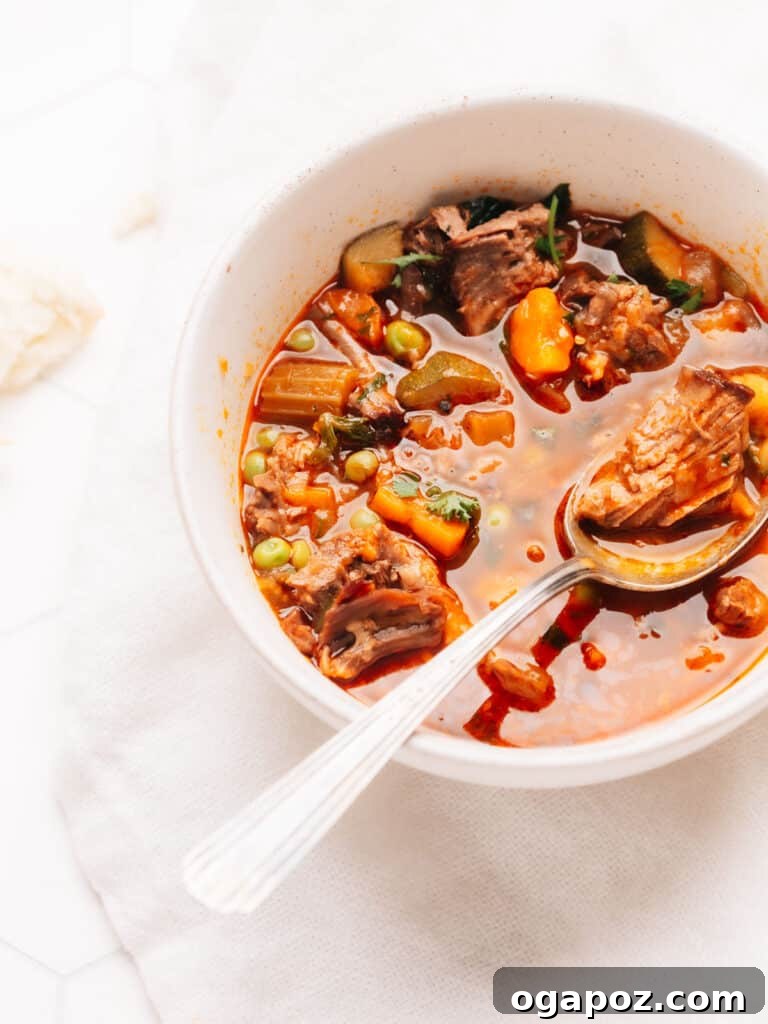 Mouthwatering Boneless Beef Ideas 10 Beef Vegetable Soup in a bowl with a spoon, showing chunky vegetables and beef.