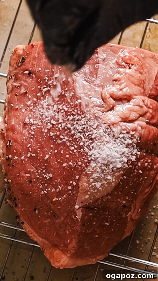 Slow-Braised Dutch Oven Beef 4 Seasoning beef roast generously with salt and pepper.