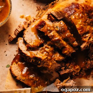 Dutch oven pot roast on a cutting board with a fork.