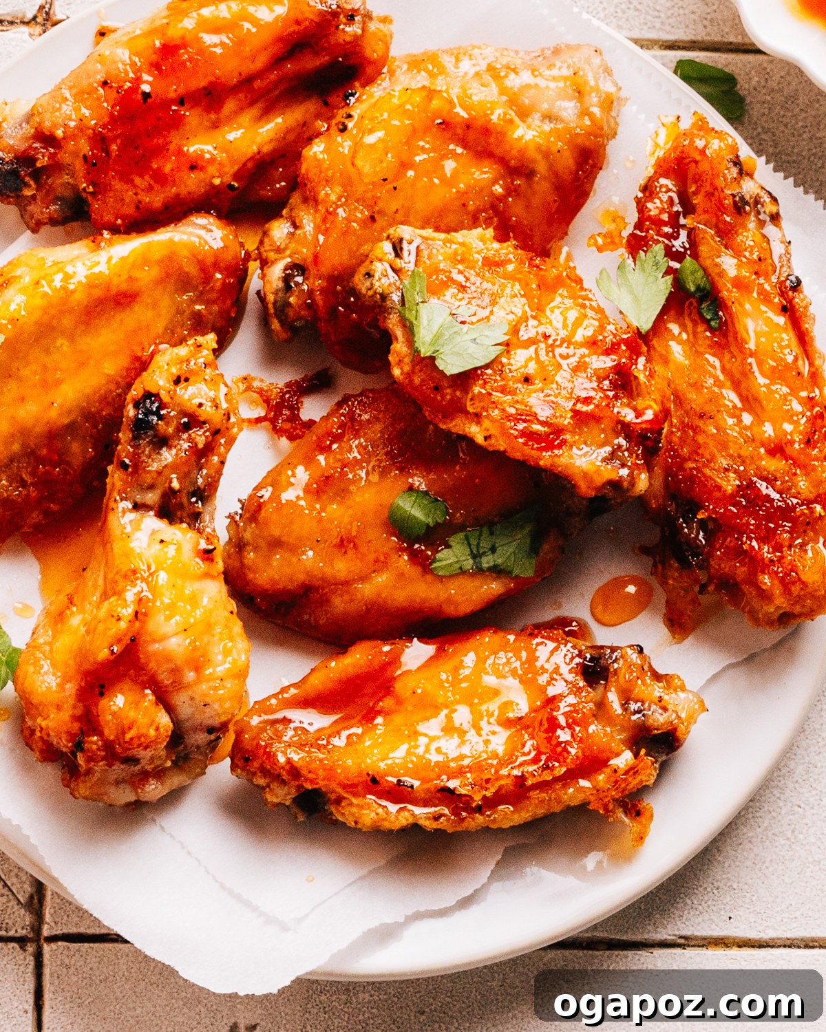 The Ultimate Chicken Wing Sauce Collection 3 Hot Honey Wings on a plate, garnished with sesame seeds.