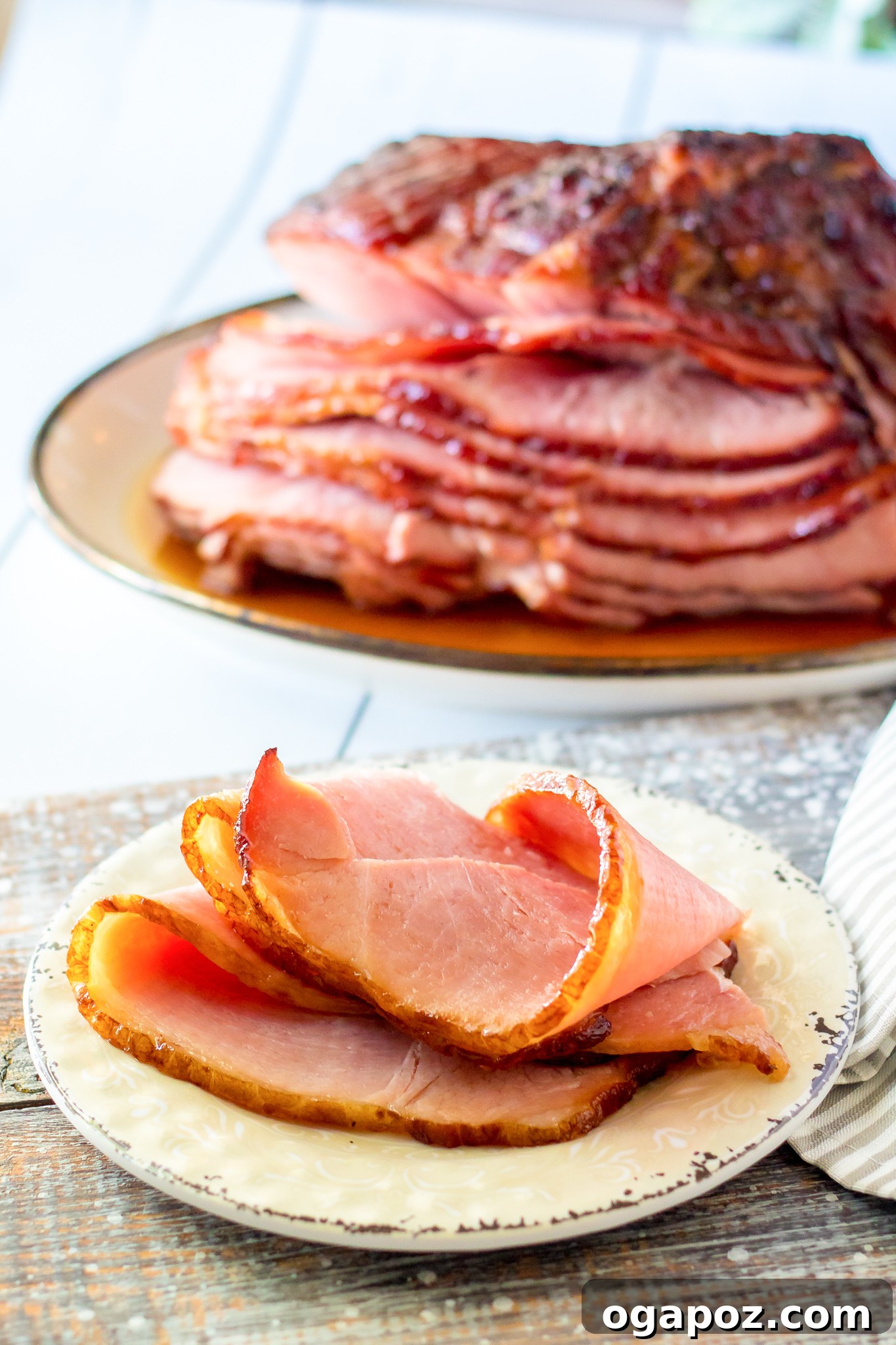 Sweet Apple Cider Glazed Ham 4 A slice of Apple Cider Glazed Ham Recipe served on a white plate.