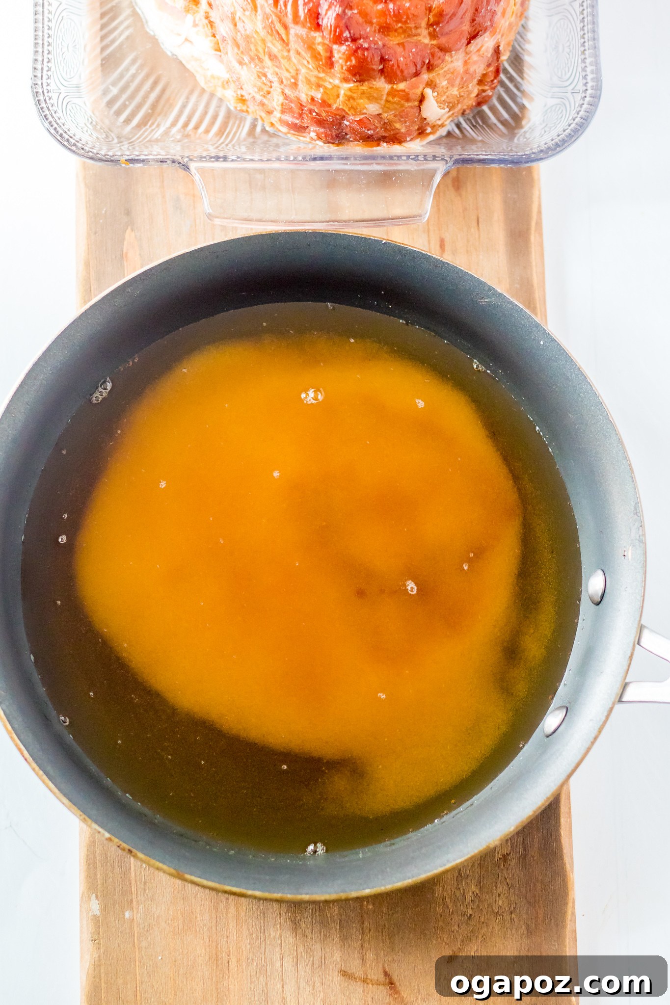 Sweet Apple Cider Glazed Ham 5 Apple Cider Glazed Ham Recipe sauce simmering in a pan.