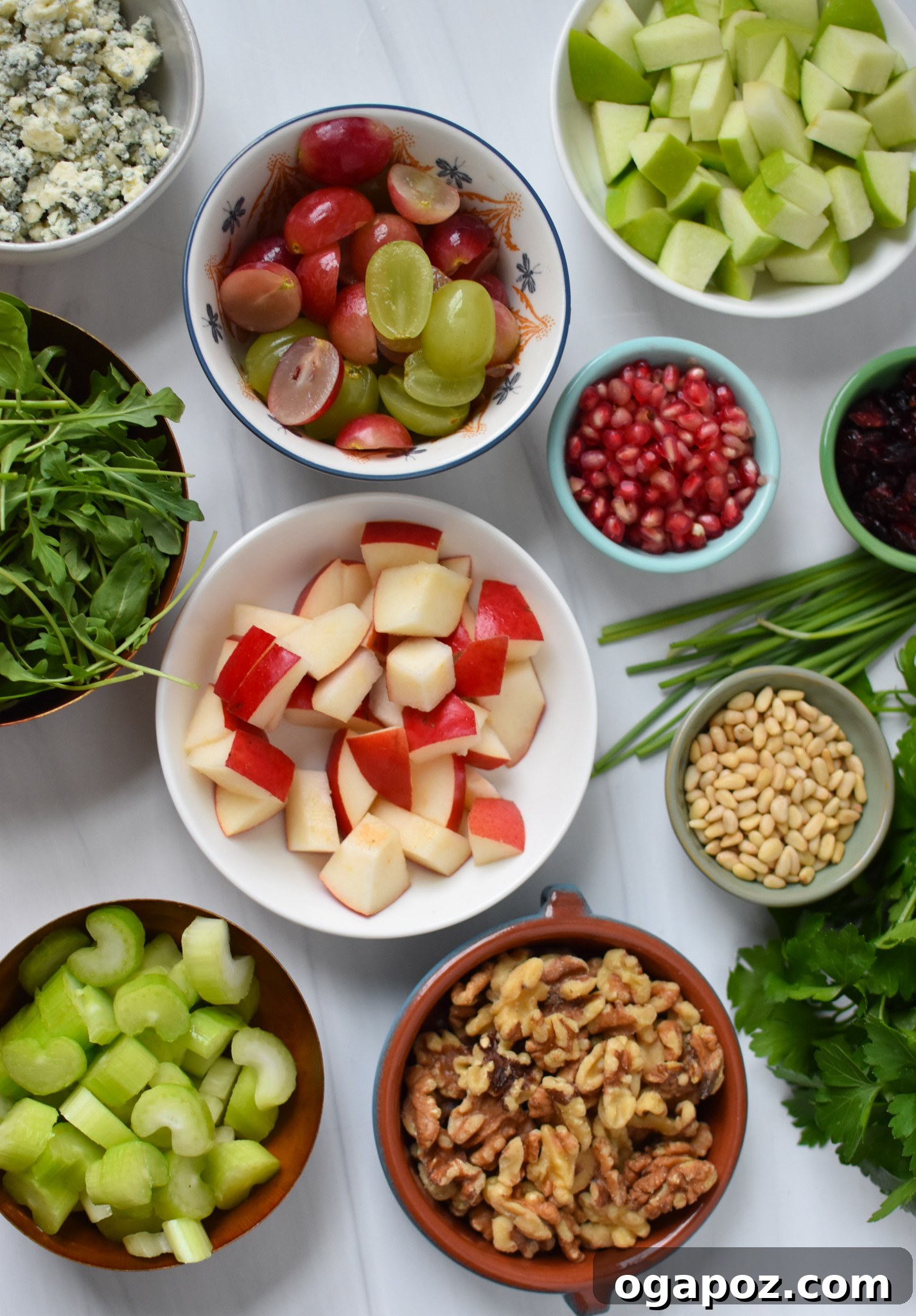 Crisp Apple and Walnut Waldorf Salad 3 Fresh ingredients laid out for a Waldorf Salad recipe, including fruit, nuts, and greens.