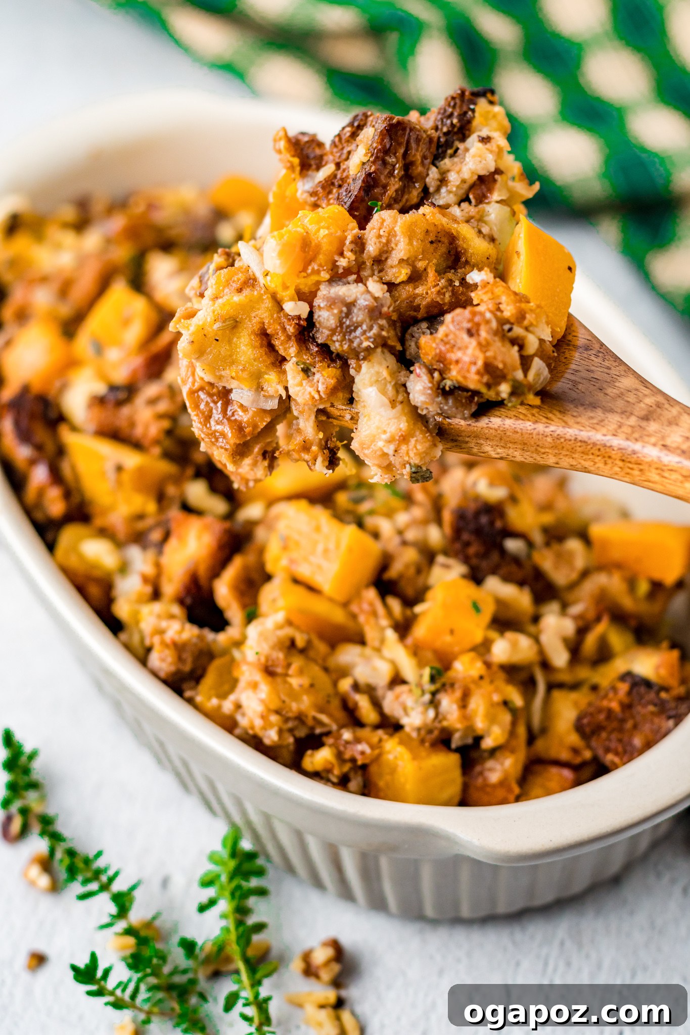Sweet and Savory Butternut Squash Stuffing 5 A serving of Butternut Squash Stuffing with a fork, showing the texture of bread, squash, and sausage.
