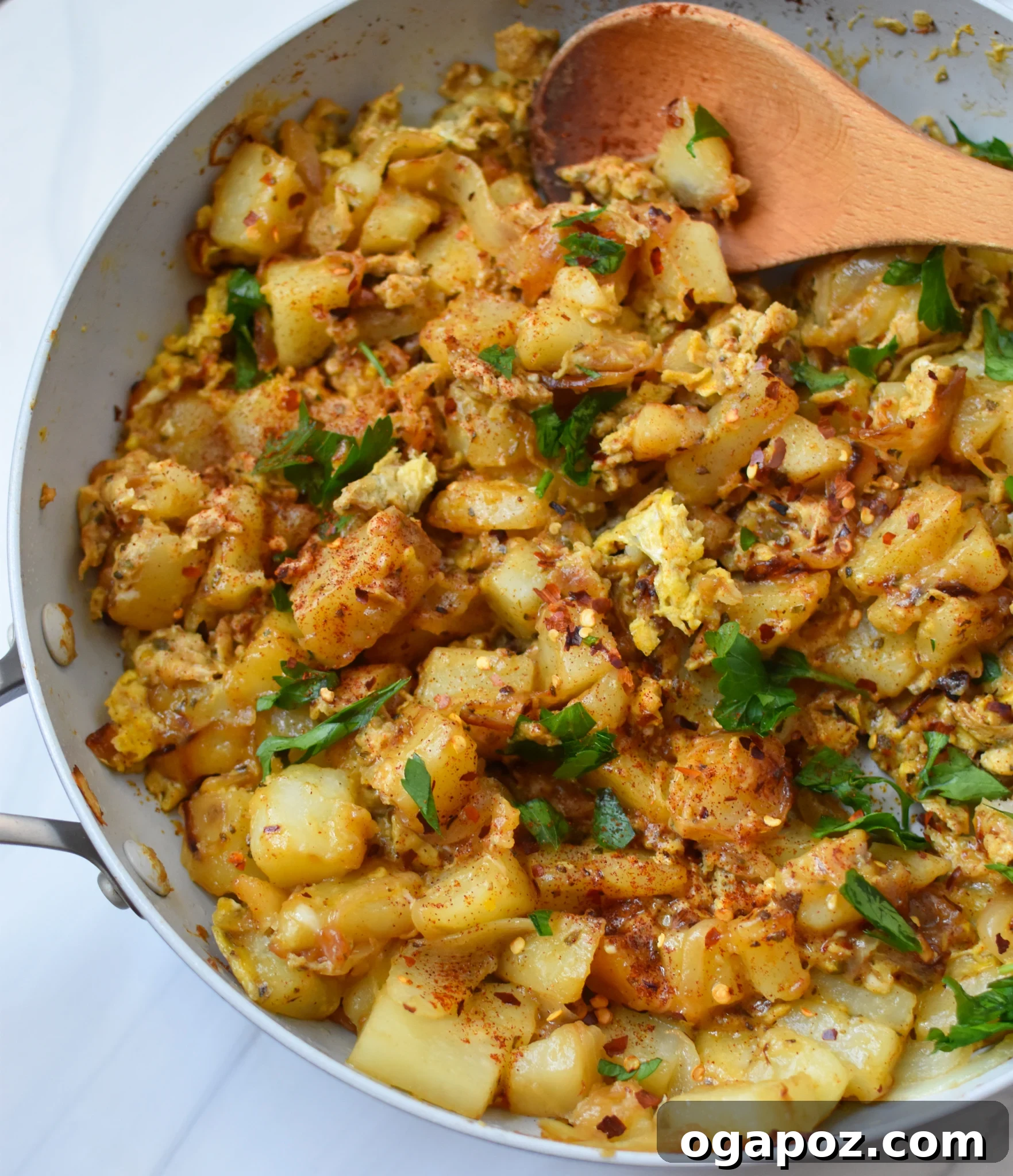 Savory Lebanese Potatoes and Eggs 2 Lebanese Potato and Egg Recipe in a pan, garnished with fresh herbs.