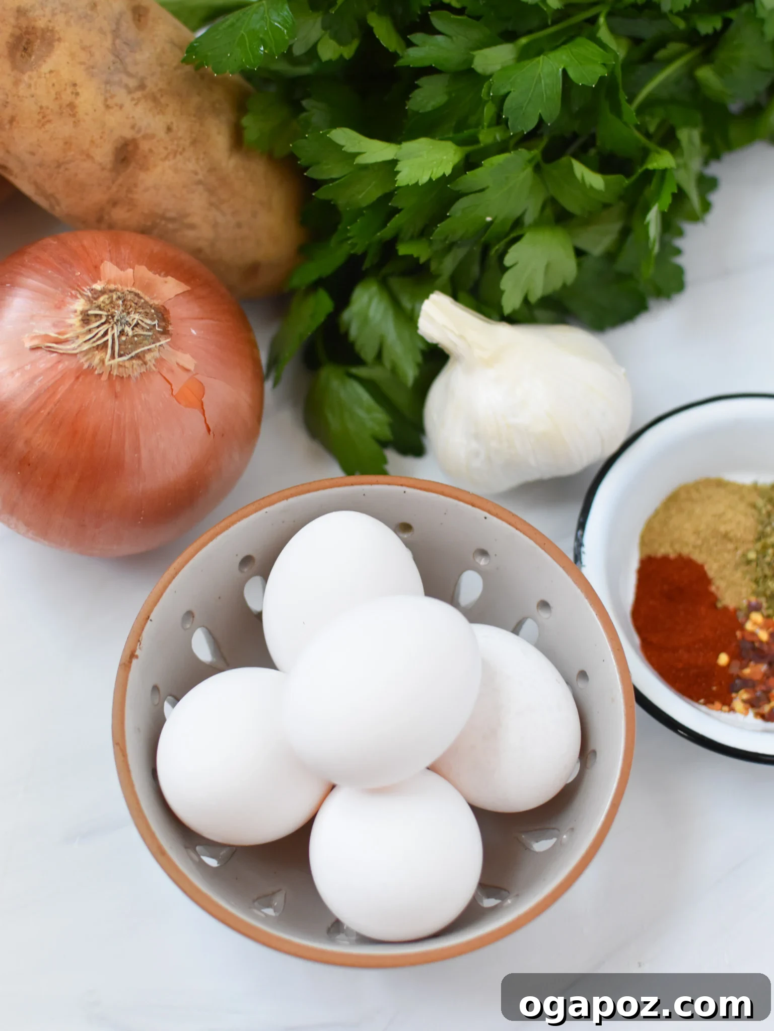 Savory Lebanese Potatoes and Eggs 4 A display of fresh ingredients for Lebanese Potato and Egg Recipe including eggs, potatoes, garlic, and spices.