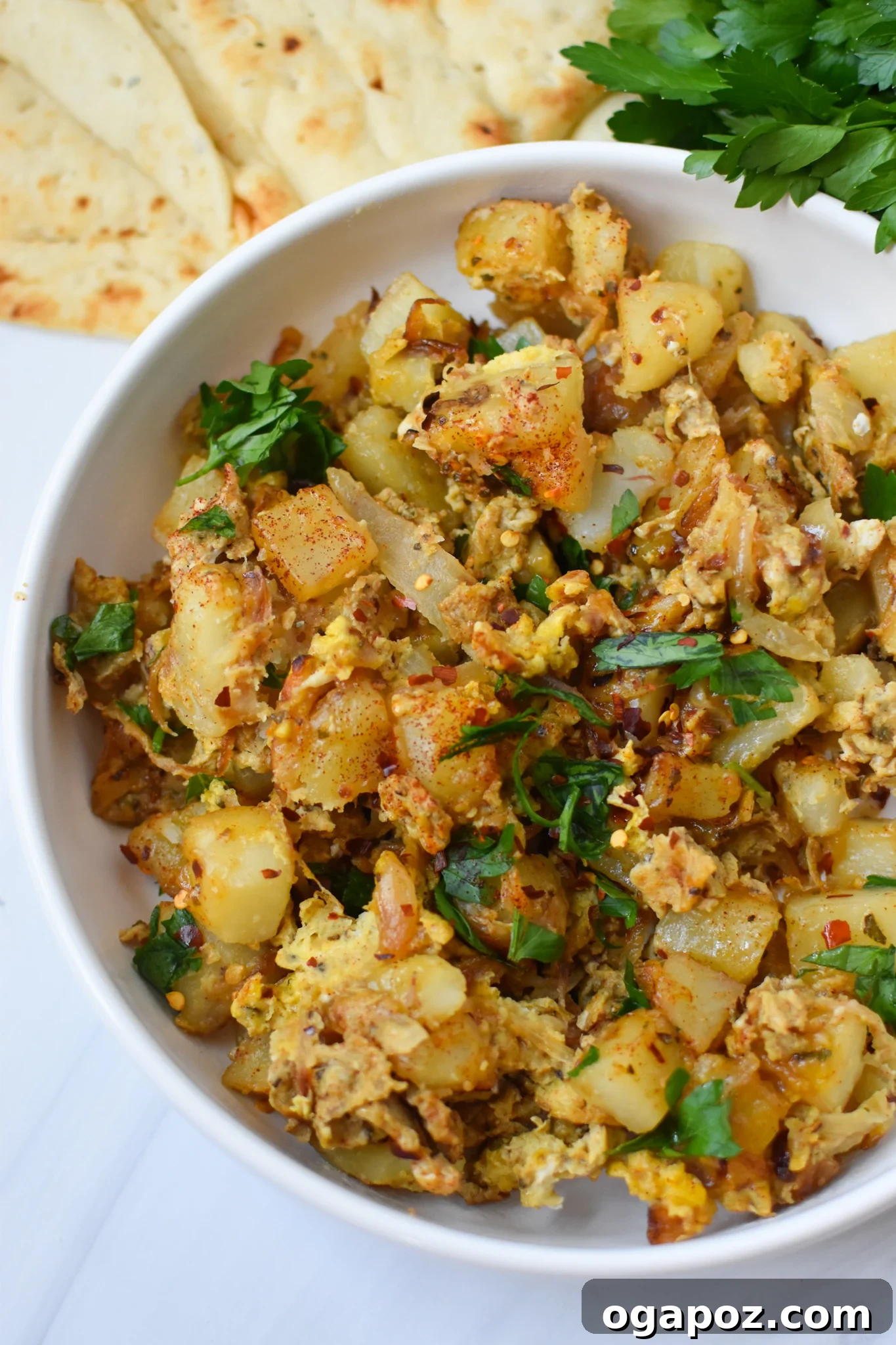 Savory Lebanese Potatoes and Eggs 5 Lebanese Potato and Egg Recipe garnished with fresh parsley.