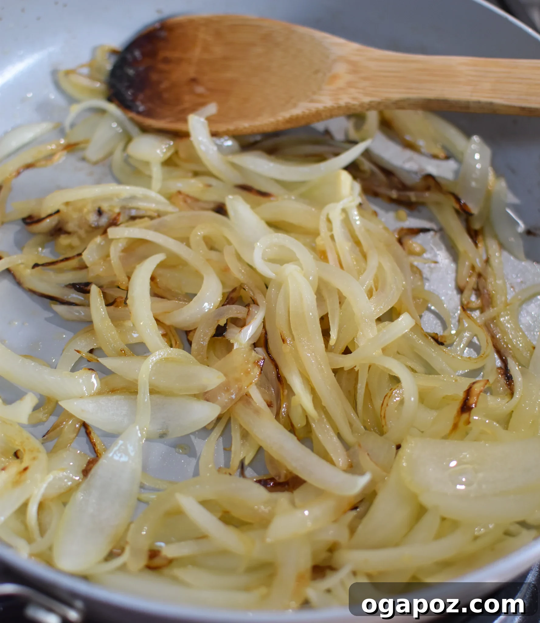 Savory Lebanese Potatoes and Eggs 7 Sautéing thinly sliced onions and minced garlic in a skillet for Lebanese Potato and Egg Recipe.