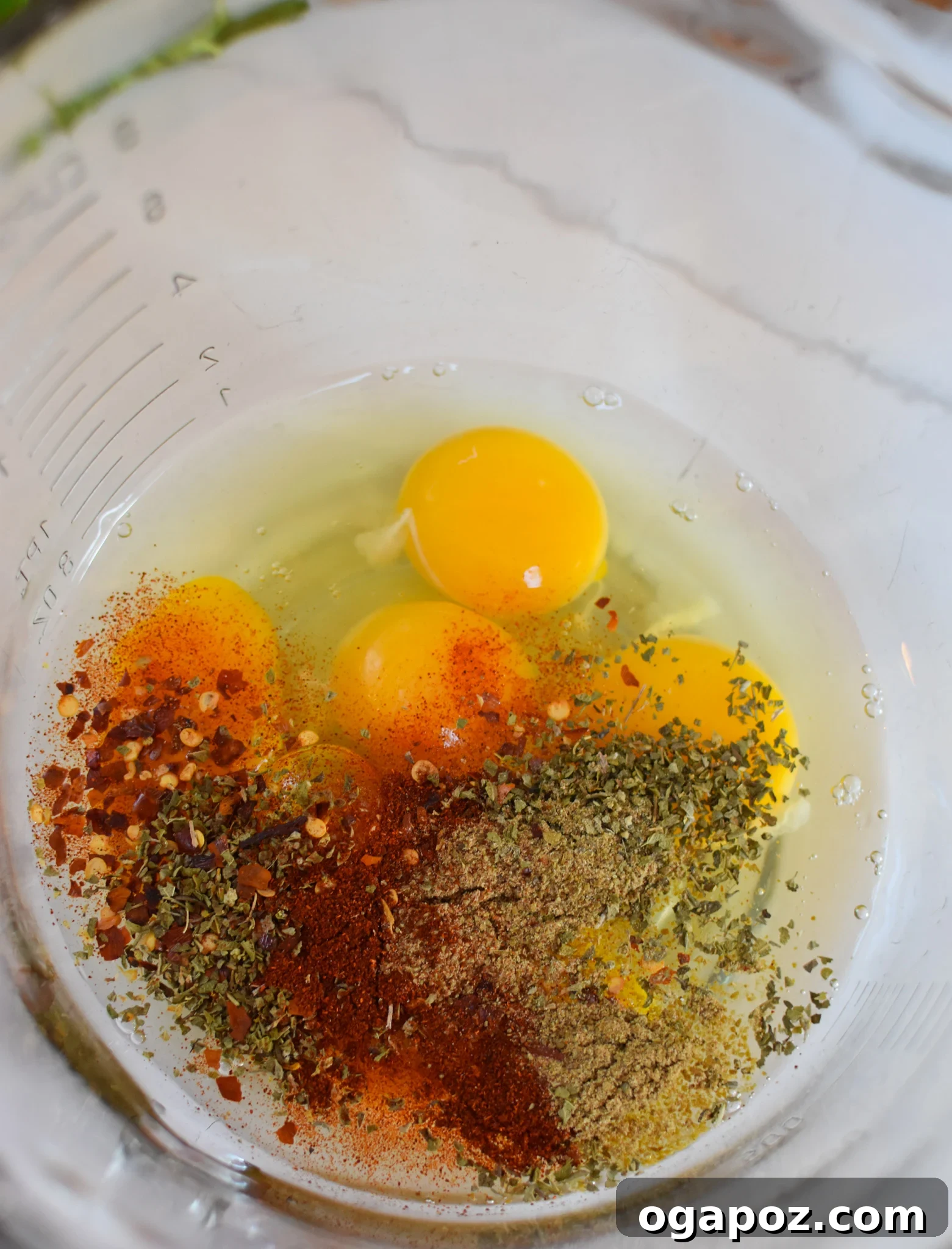 Savory Lebanese Potatoes and Eggs 9 Mixing eggs and spices in a bowl, preparing for the Lebanese Potato and Egg Recipe.