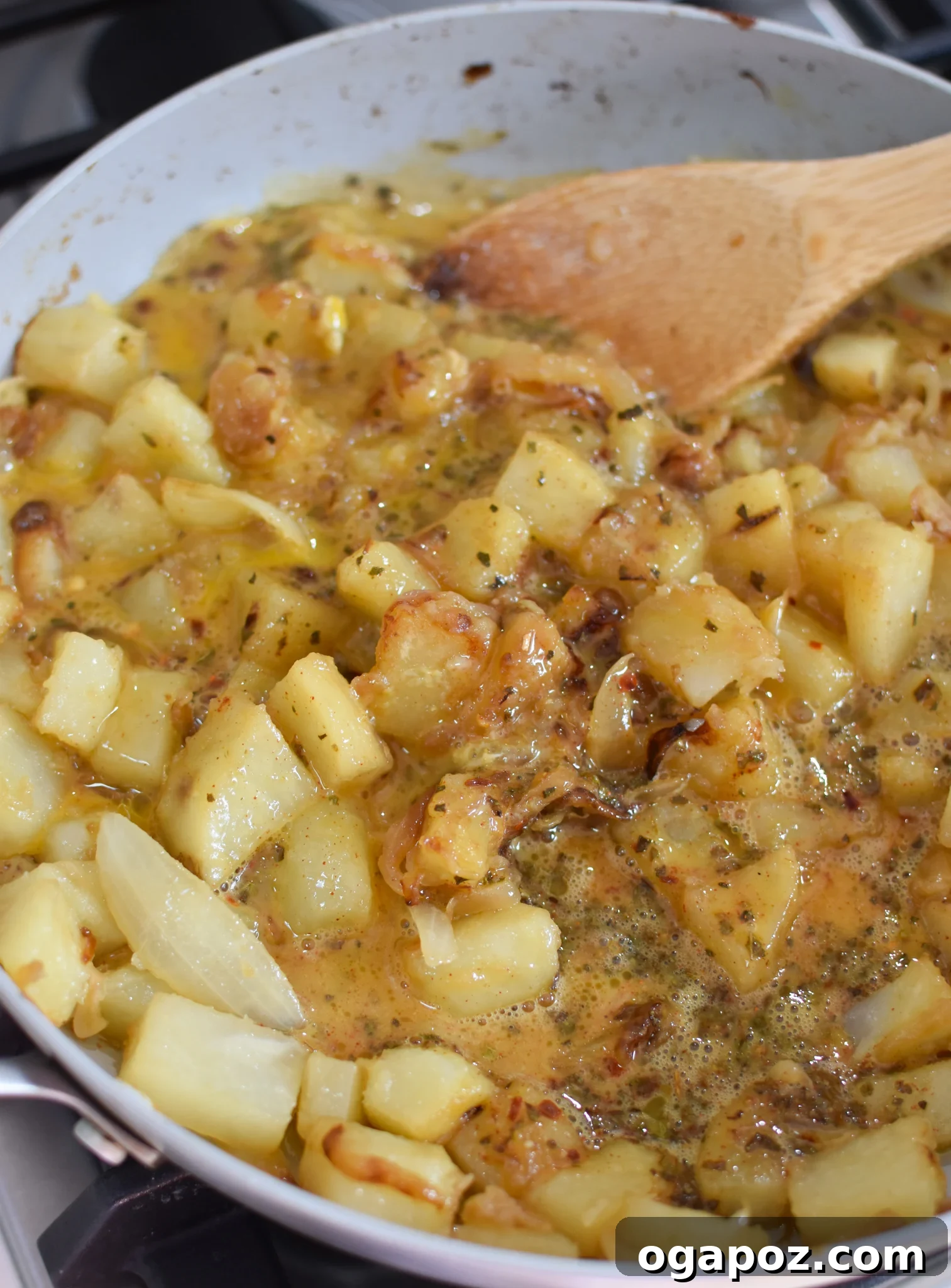 Savory Lebanese Potatoes and Eggs 10 Lebanese Potato and Egg Recipe with scrambled eggs mixed into the skillet, ready for final touches.