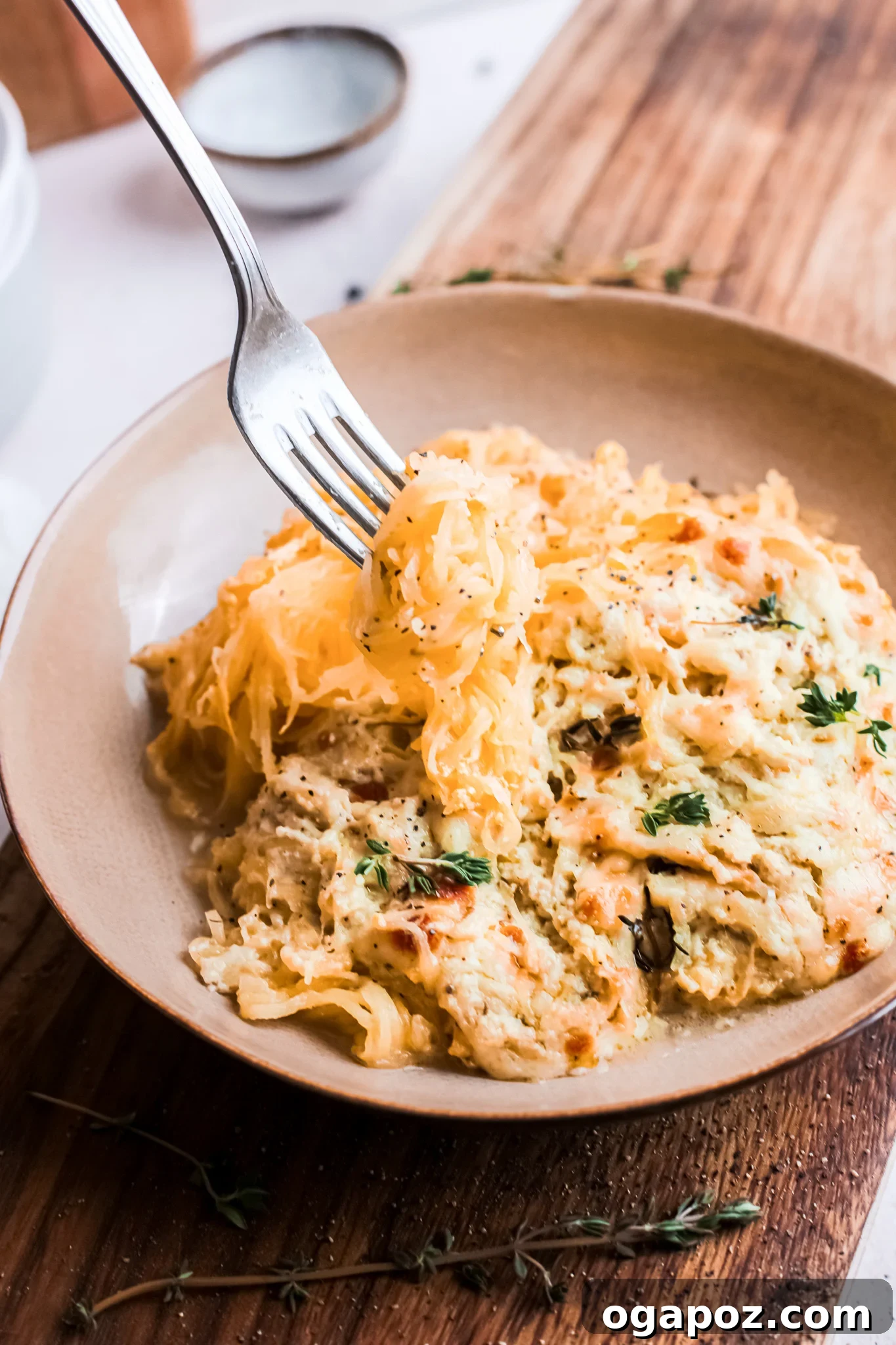 Golden Cheesy Spaghetti Squash Bake 4 A fork taking a scoop of Baked Cheesy Spaghetti Squash, showcasing the cheesy strands.