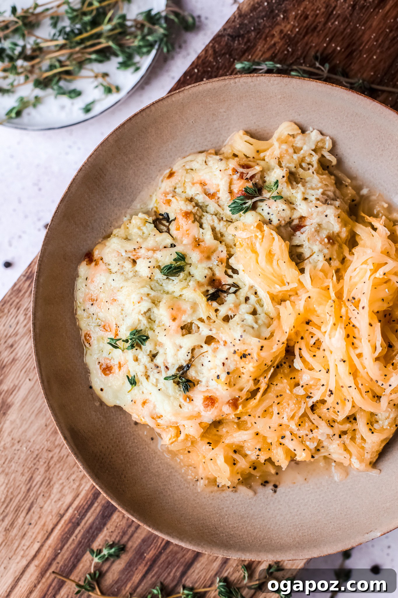 Golden Cheesy Spaghetti Squash Bake 7 Baked Cheesy Spaghetti Squash Recipe garnished with cheese and fresh herbs, ready to be enjoyed.