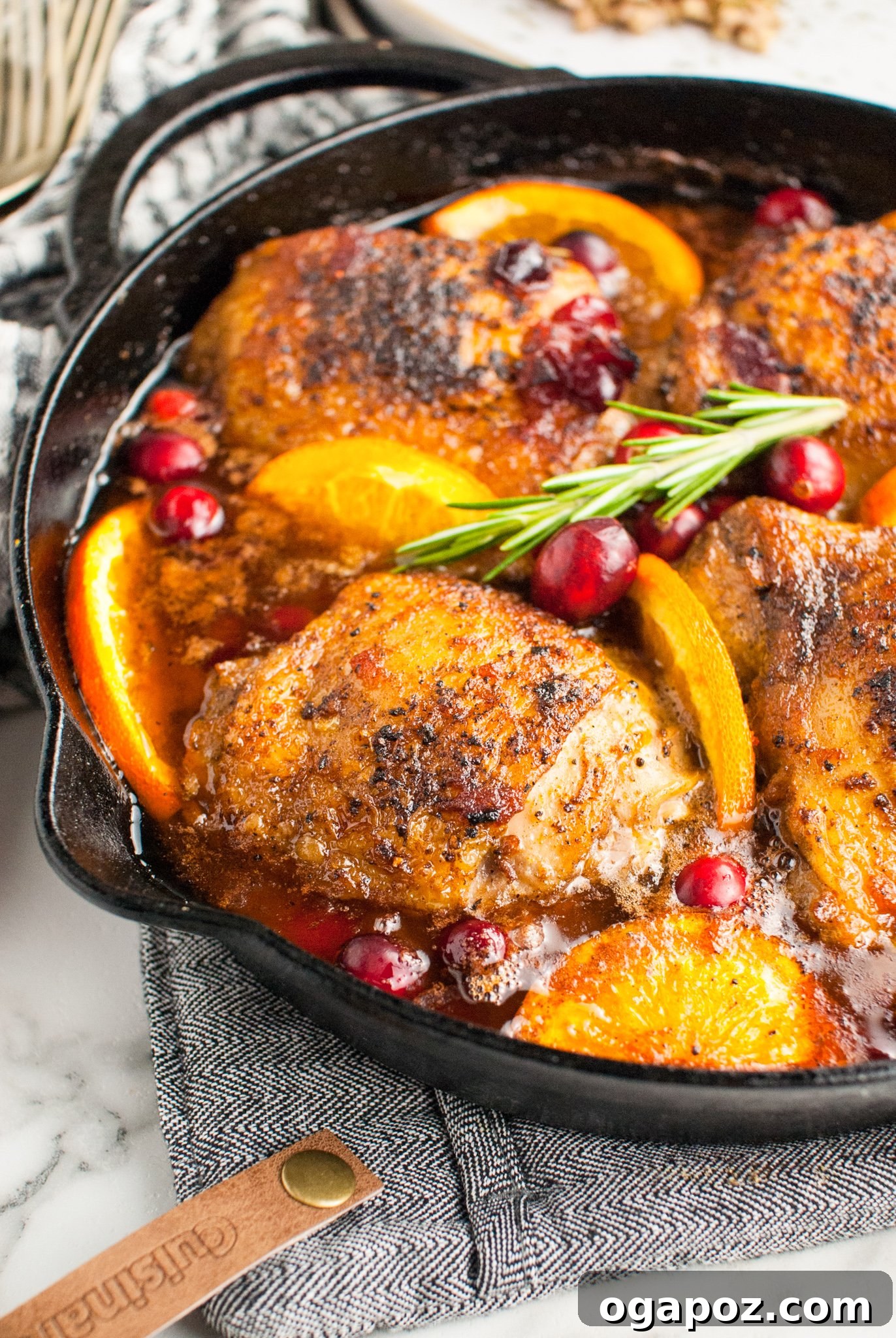 Effortless Cranberry Glazed Chicken Thighs 6 Easy Baked Chicken Thighs garnished with fresh rosemary.